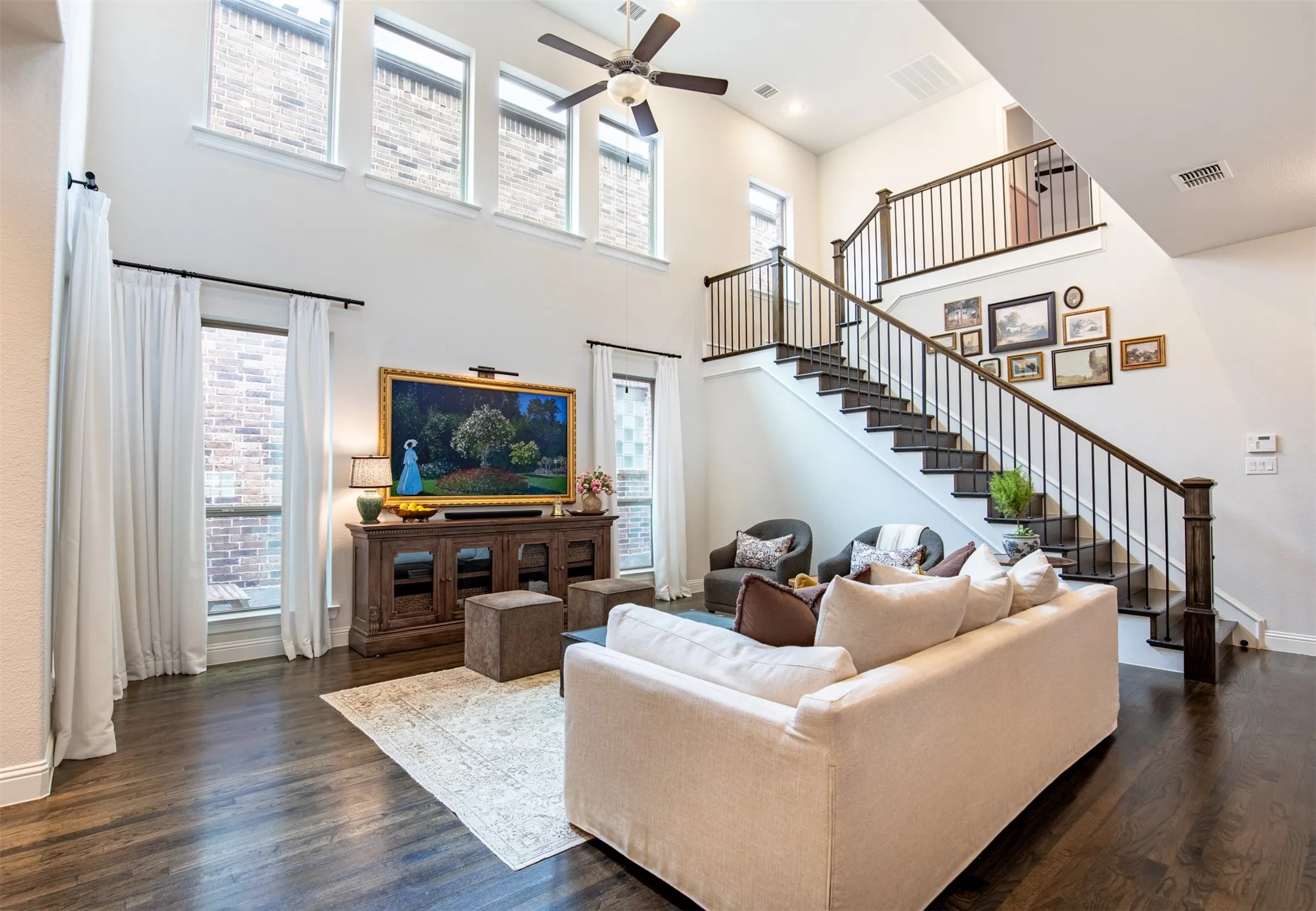 Living area featuring vaulted ceilings and wood floors. Spacious and Airy!