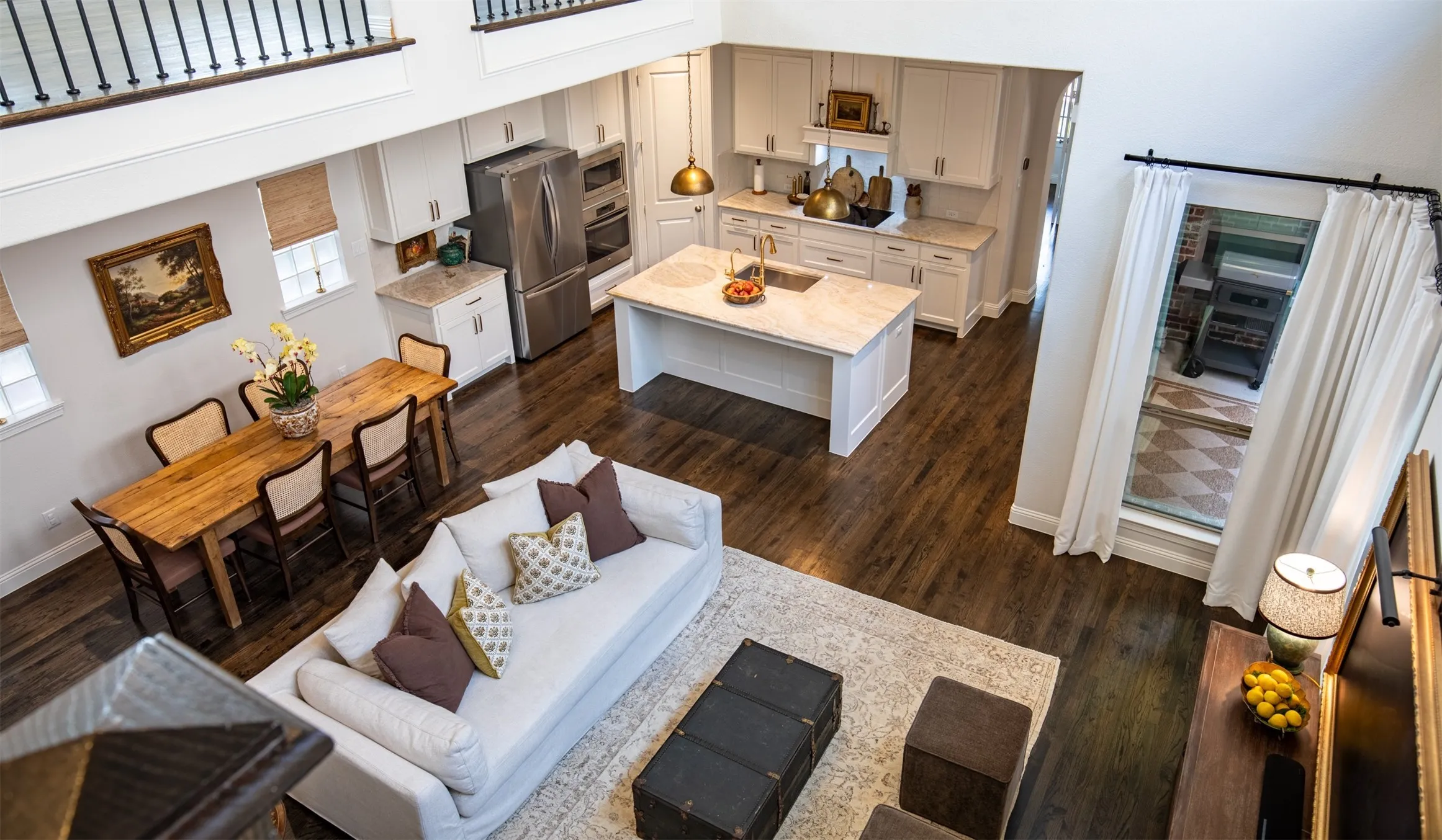 Living area featuring vaulted ceilings and wood floors. Spacious and Airy!