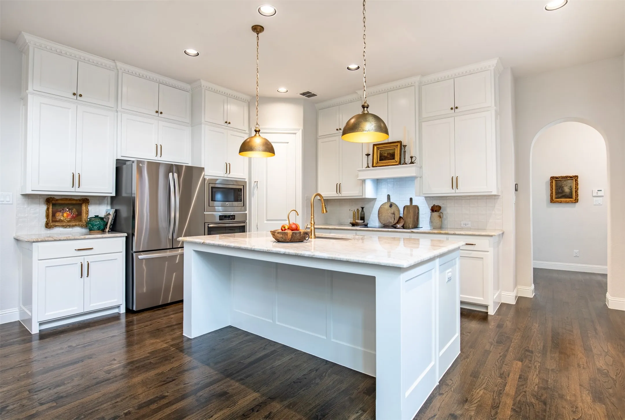 Kitchen with updated white cabinetry and built-in induction stove