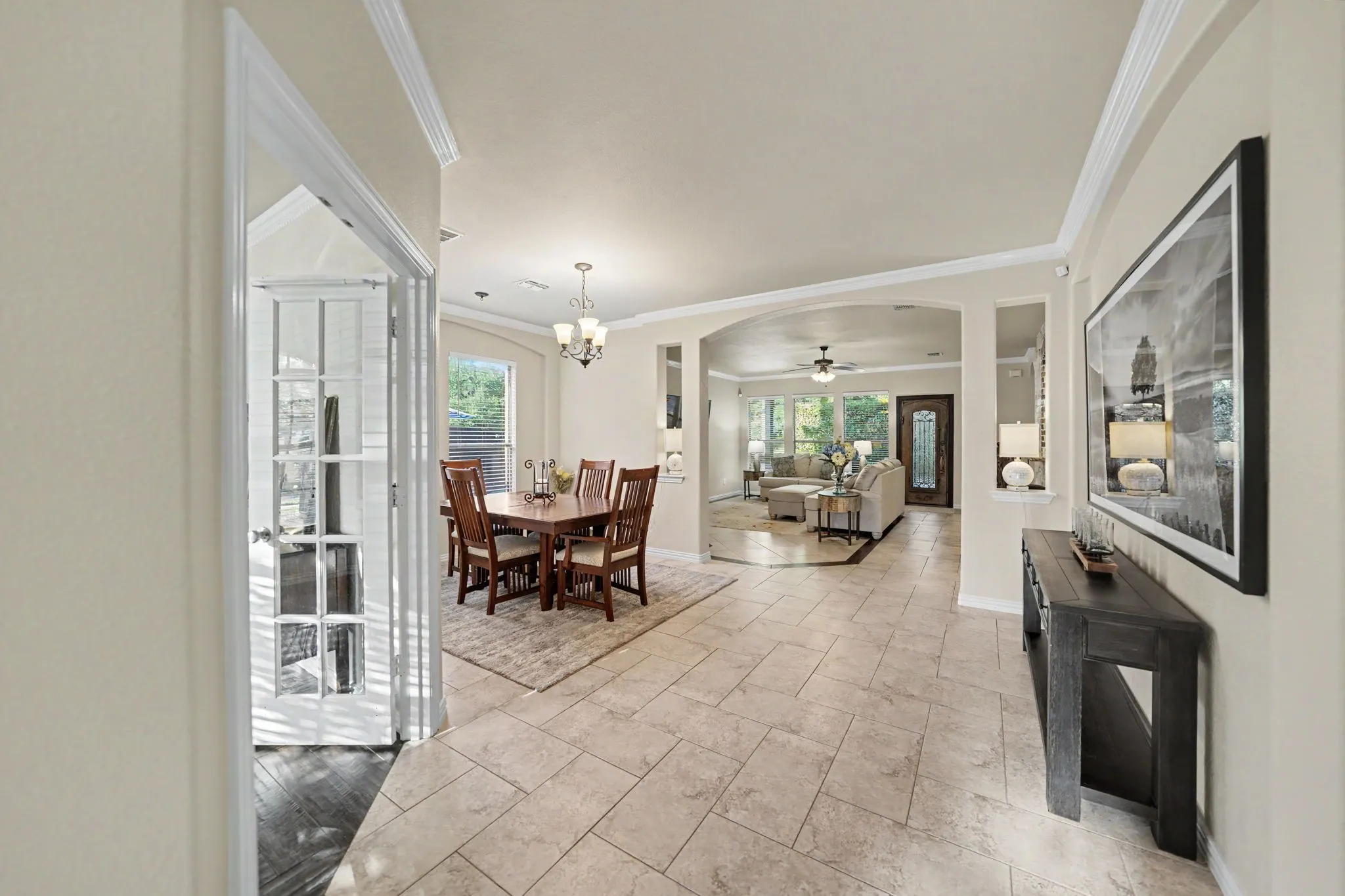 Office to the left with french glass window doors,  wide entry way leads to dining area, living room, and kitchen
