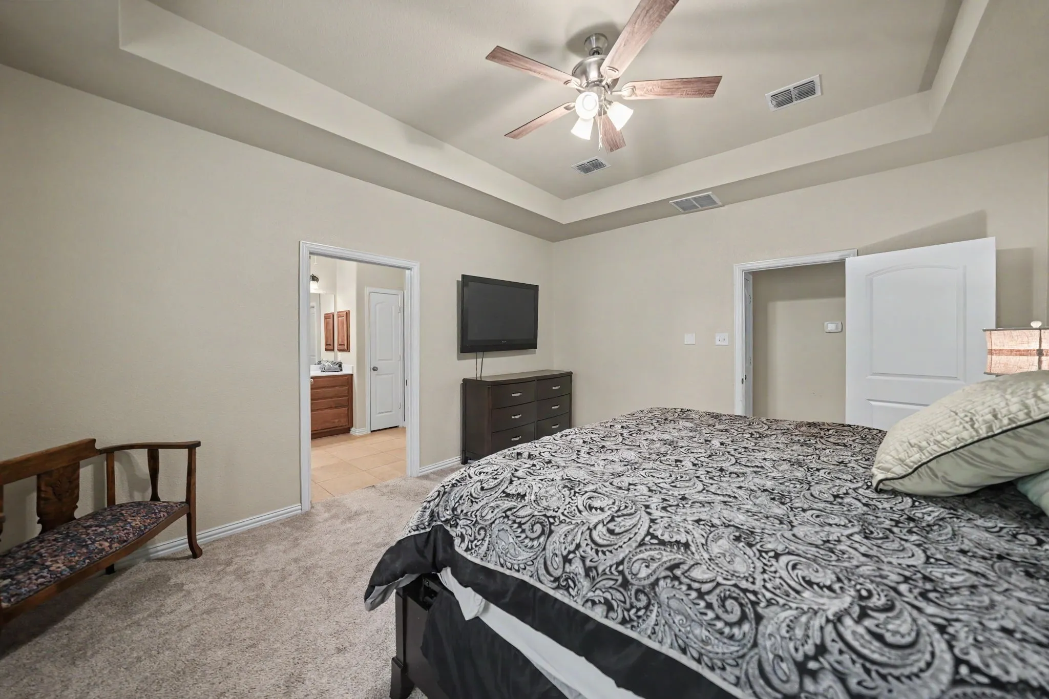 tray ceilings in primary suite which leads to the primary bath and CUSTOM CLOSET with WINCHESTER SAFE