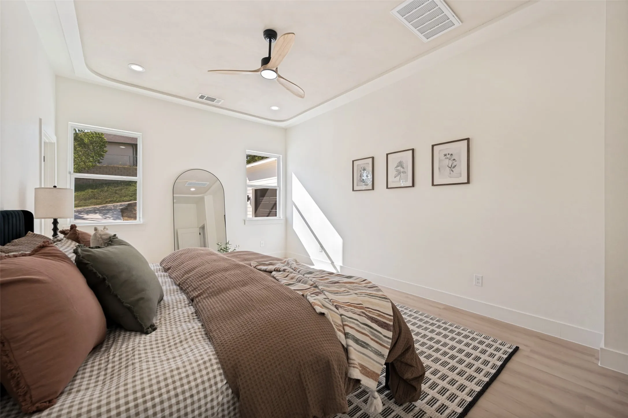 Recessed lighting with a decorative ceiling fan, light wood-finish flooring, and white walls
