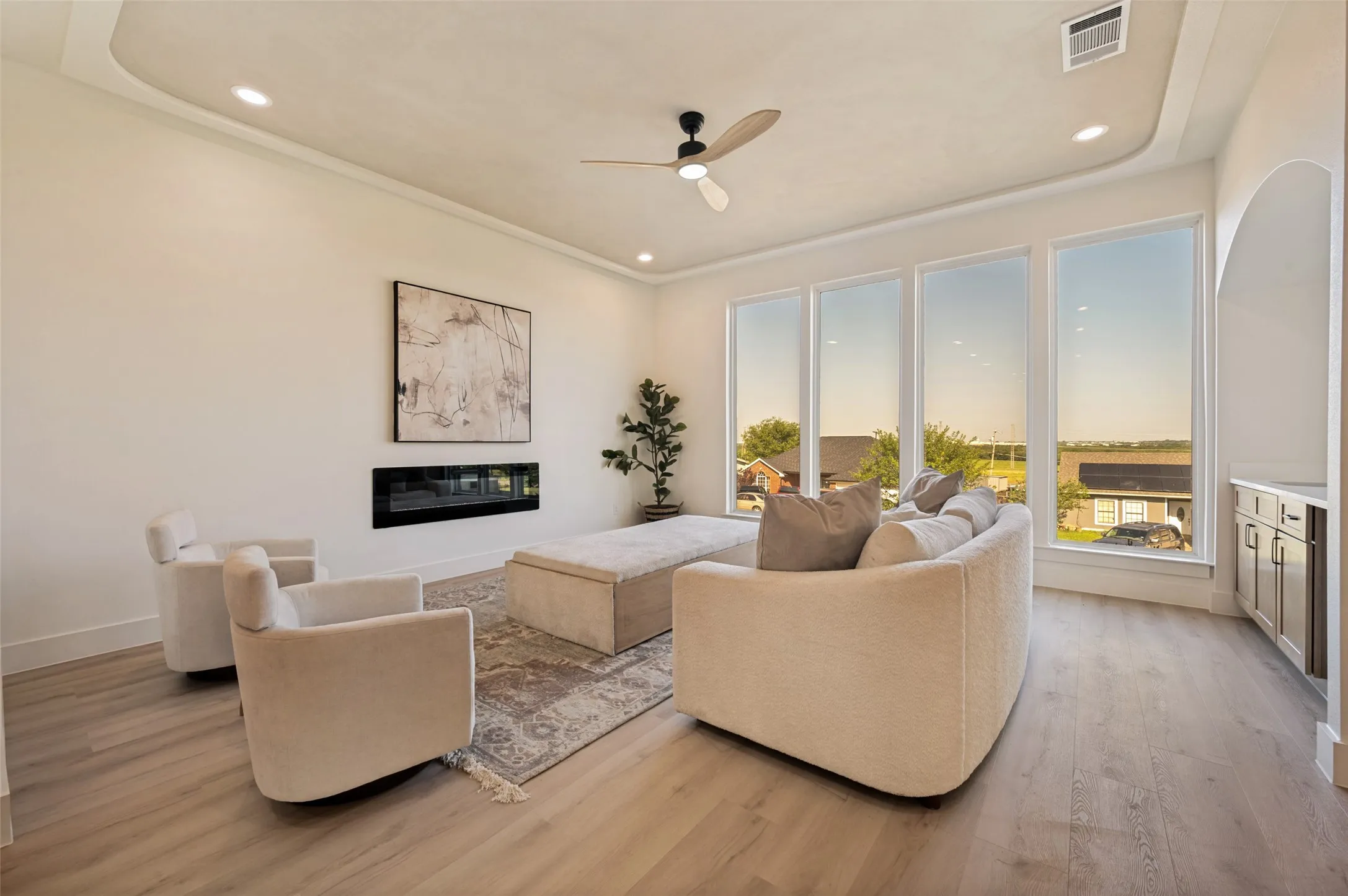 Living area with recessed lighting, crown molding, and wood-finish flooring