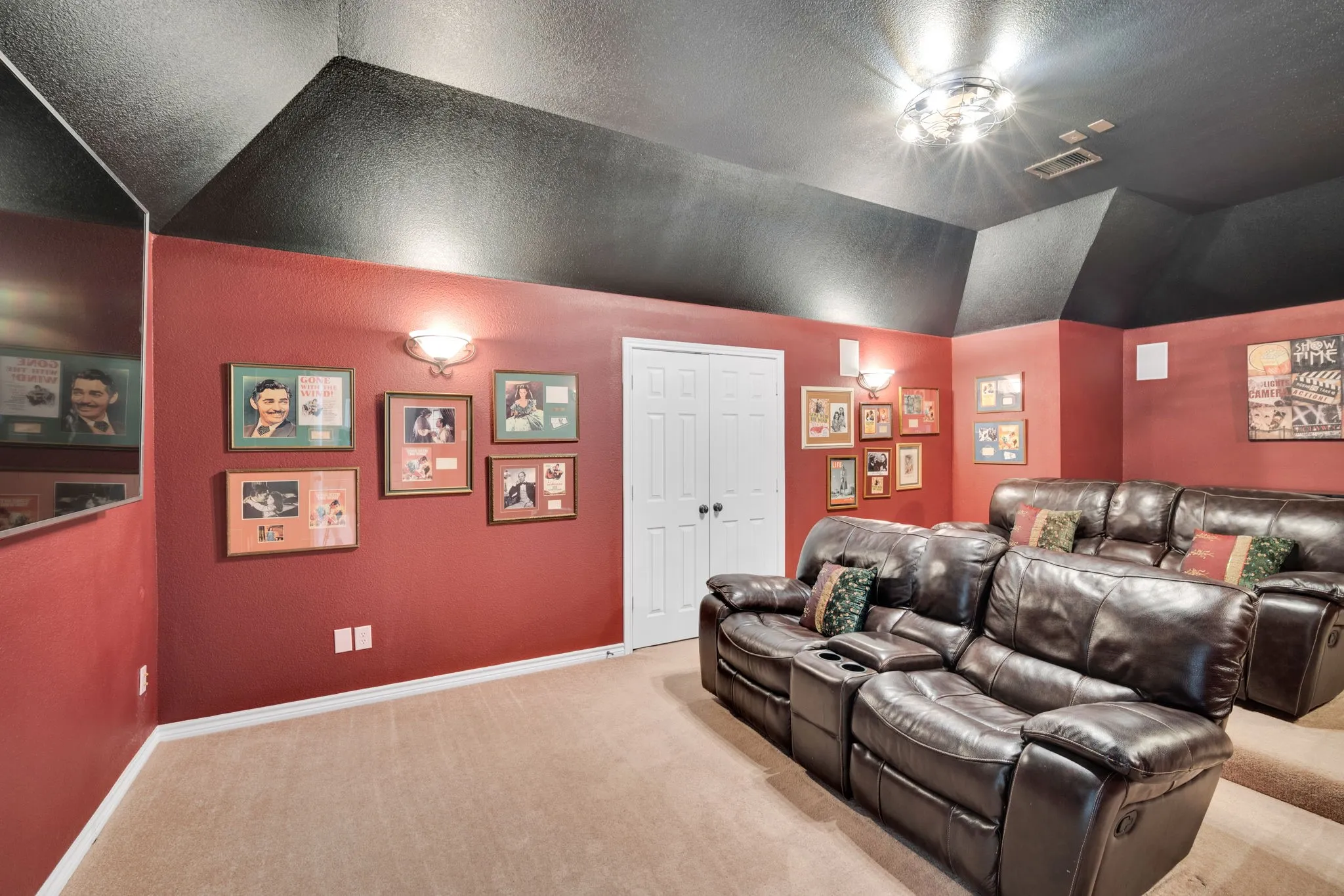 Media room with dramatic vaulted ceilings and bold accent walls, ideal for movie nights.