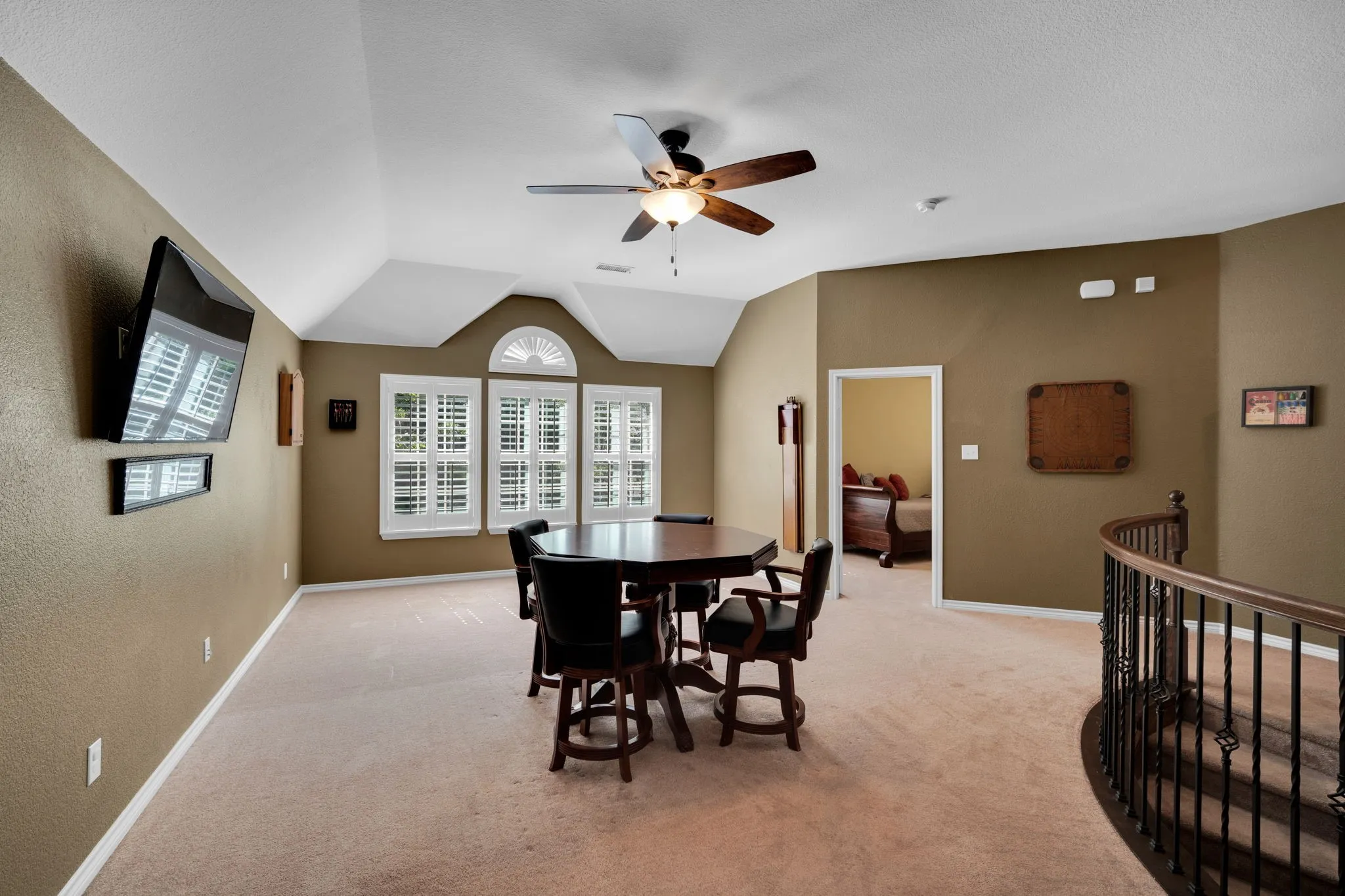 Spacious upstairs loft with a vaulted ceiling and open overlook, the perfect spot for a game room or second living area.