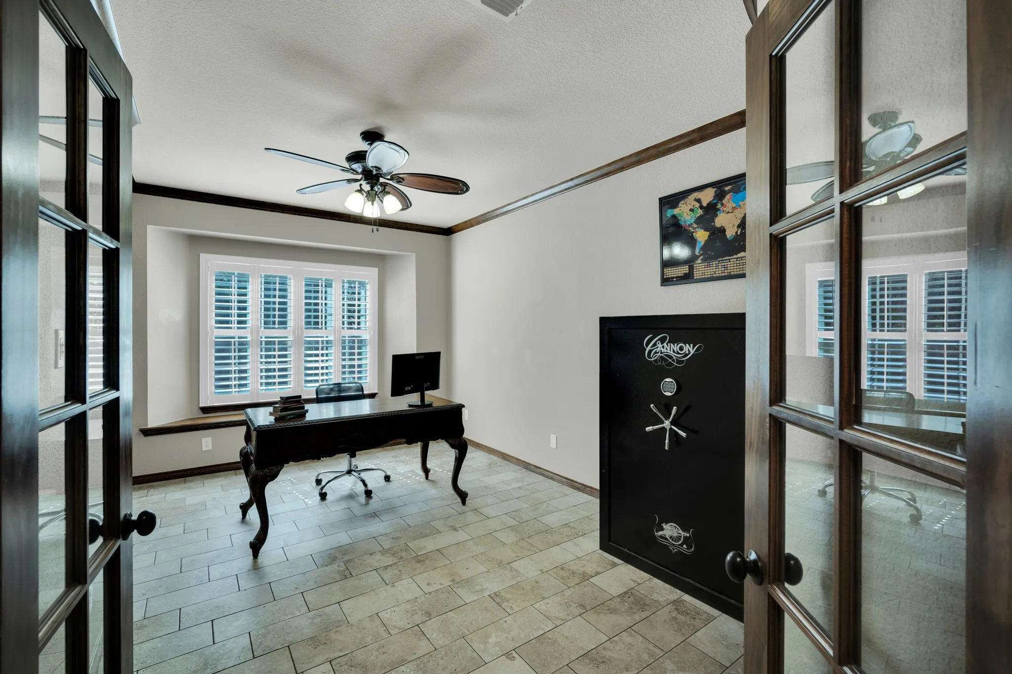 Private office with French doors and large windows, a quiet retreat for working from home.