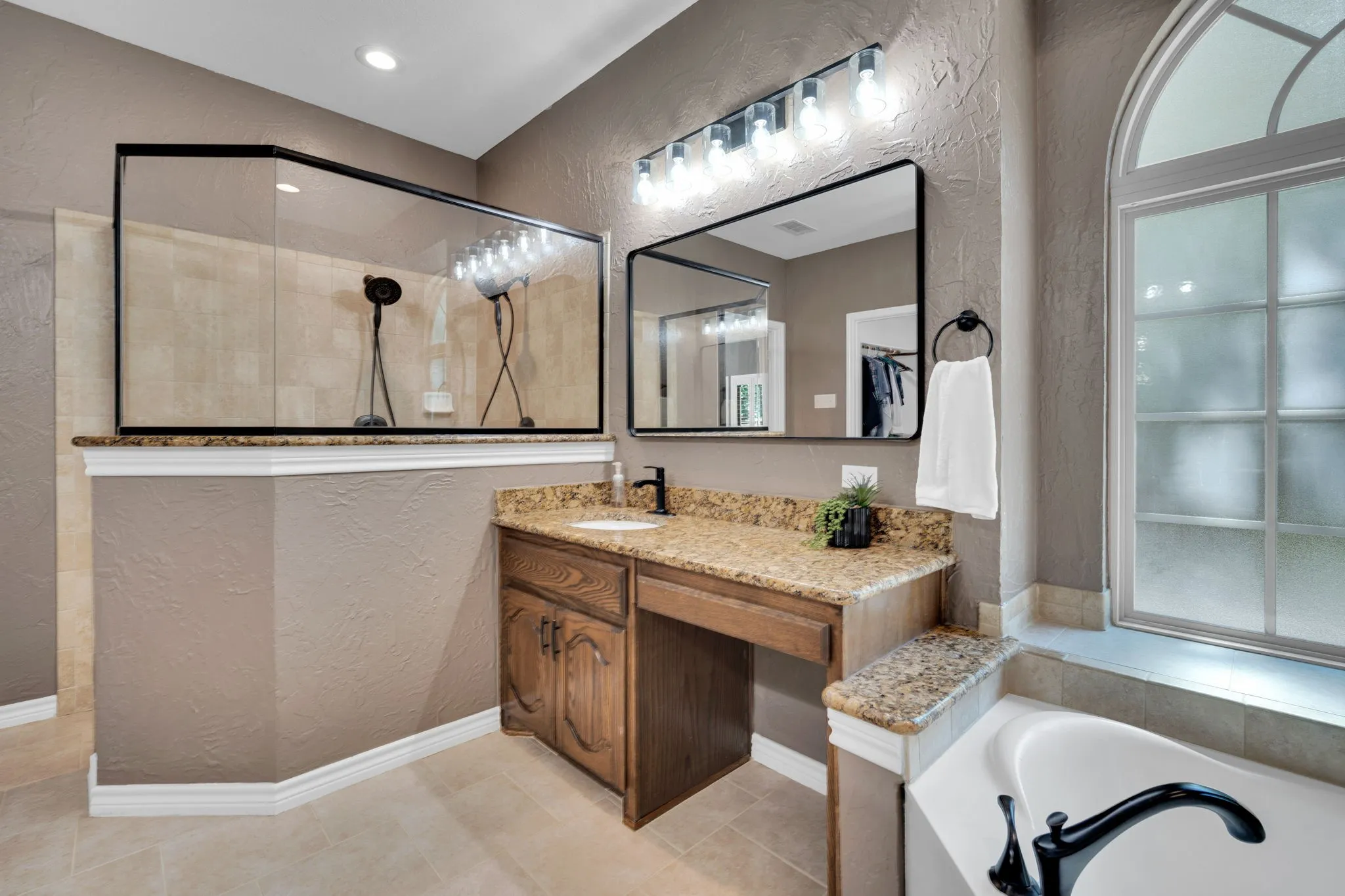 Primary bath with dual vanities and a walk-in shower for a true spa-day feel.