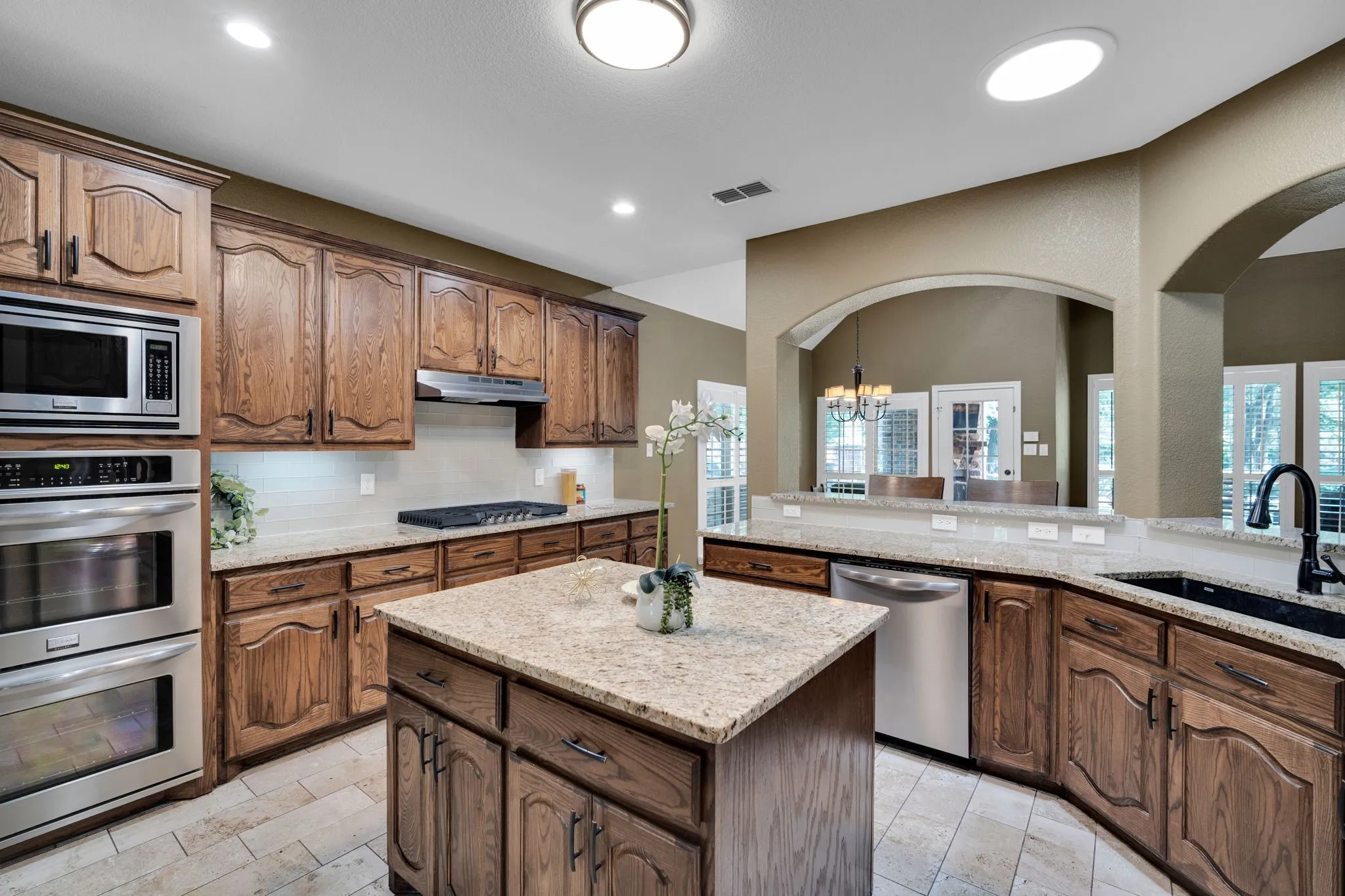 Well-appointed kitchen with a large island, double ovens, and an open flow into the living spaces.