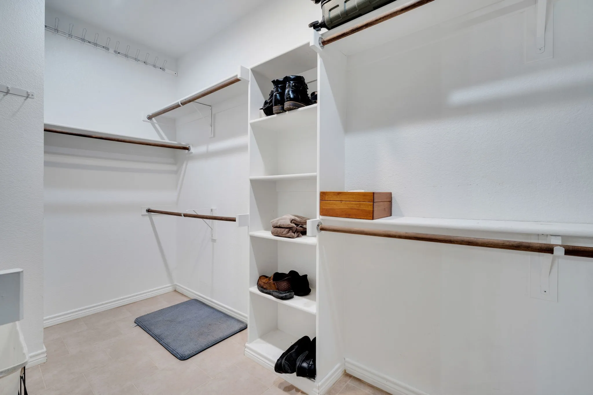 Expansive walk-in closet with extensive built-in shelving for abundant storage.