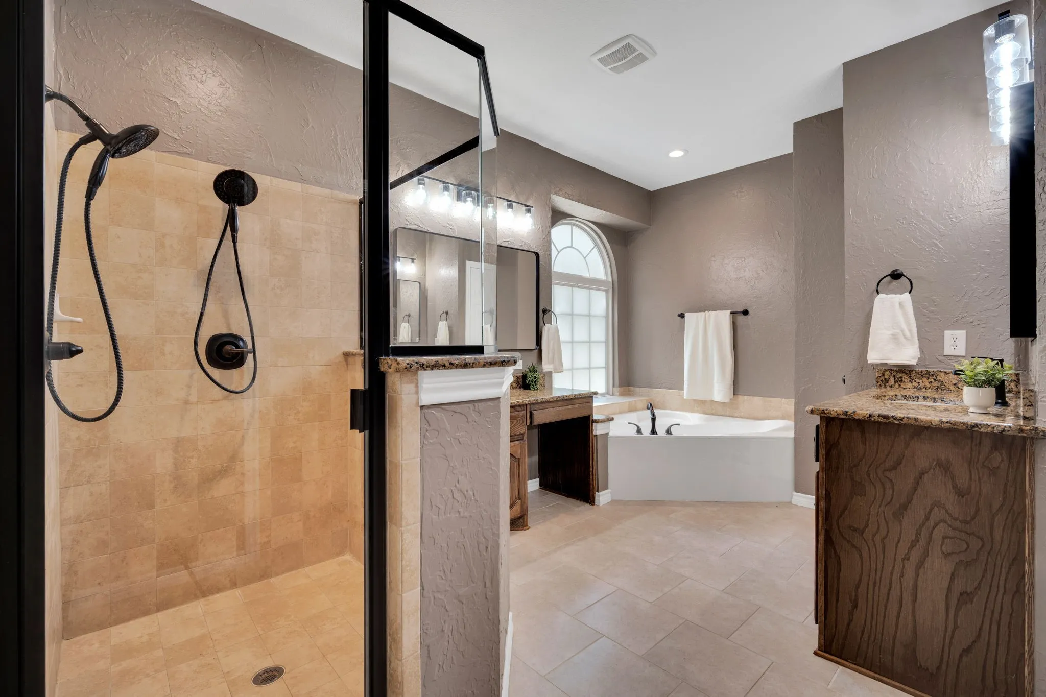 Spa-like primary bath with a walk-in shower and a separate soaking tub.