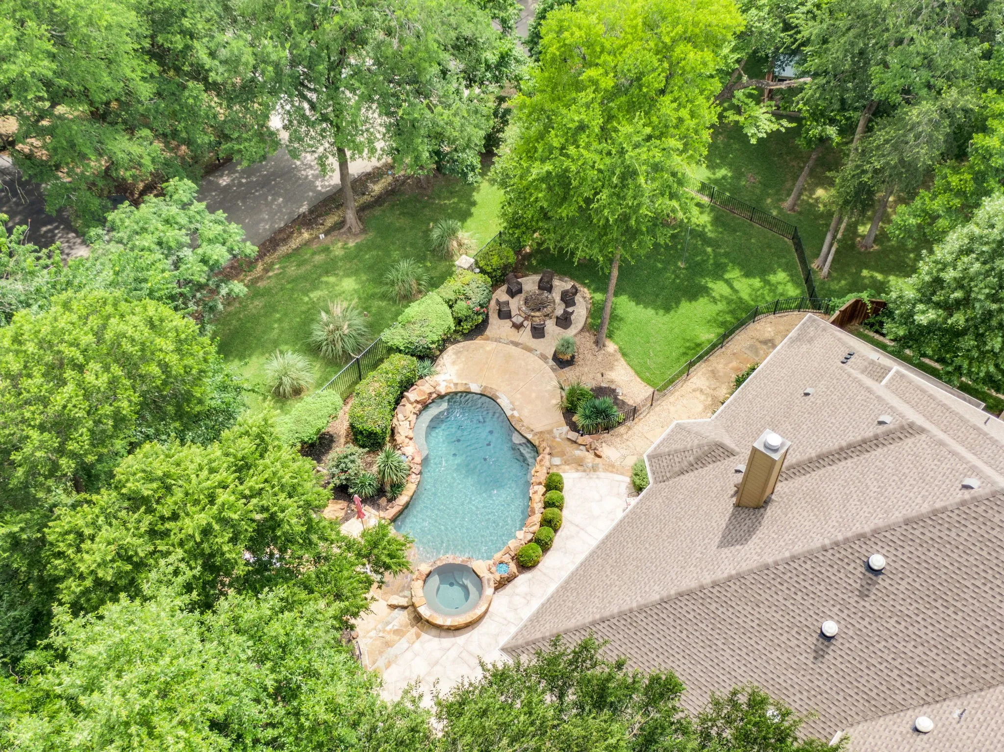 Aerial view of the backyard oasis, showcasing the pool and mature landscaping.