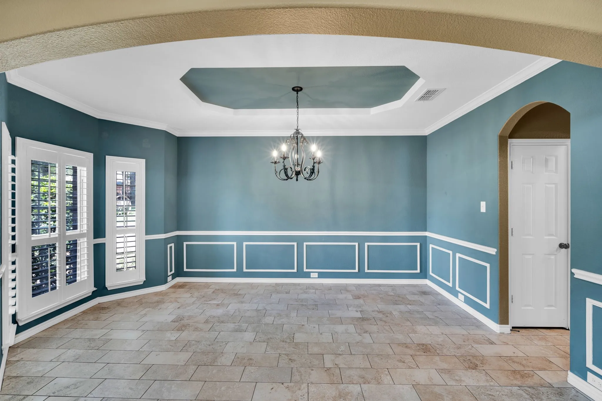 Elegant formal dining room with tray ceiling.