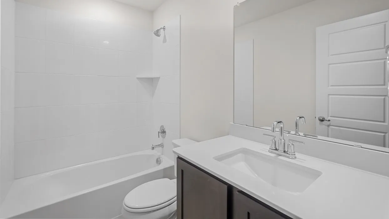 Bathroom featuring a tub and shower combination with white subway tile surround and a built-in shower niche