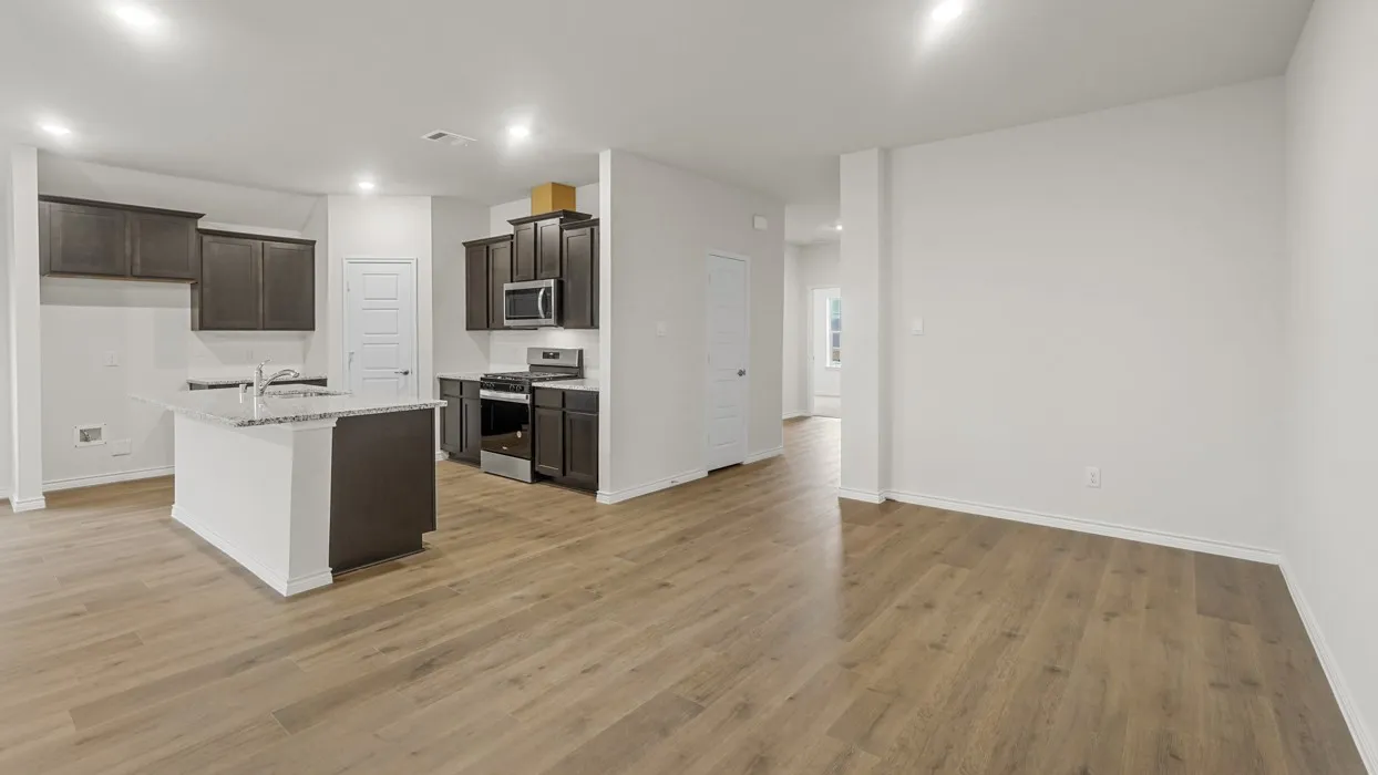 Open-concept kitchen and living area featuring wood-finish flooring