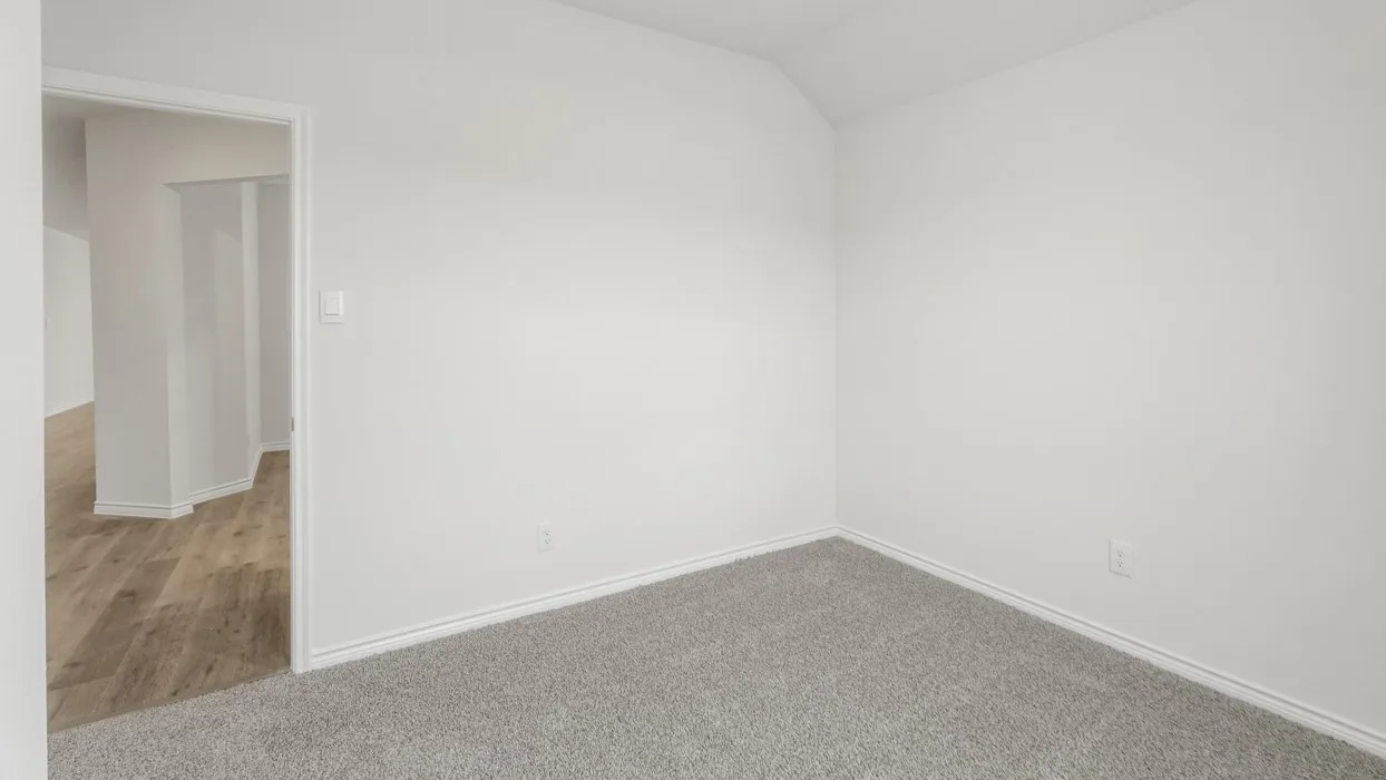 Neutral white walls and light gray carpet create a bright interior