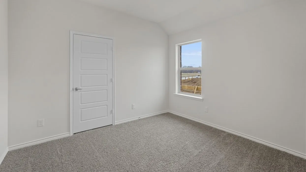 Carpeted room with a single window, white walls, and a five-panel interior door