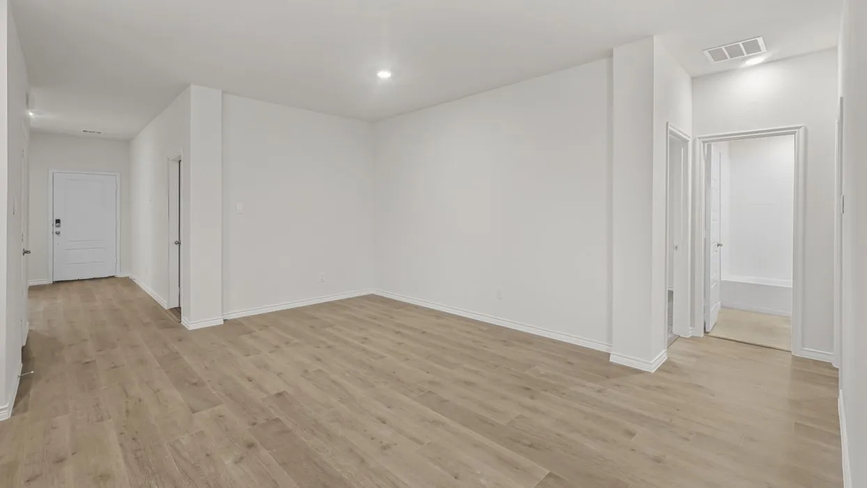 Spacious interior featuring wood-finish flooring, recessed lighting, white walls, and white trim