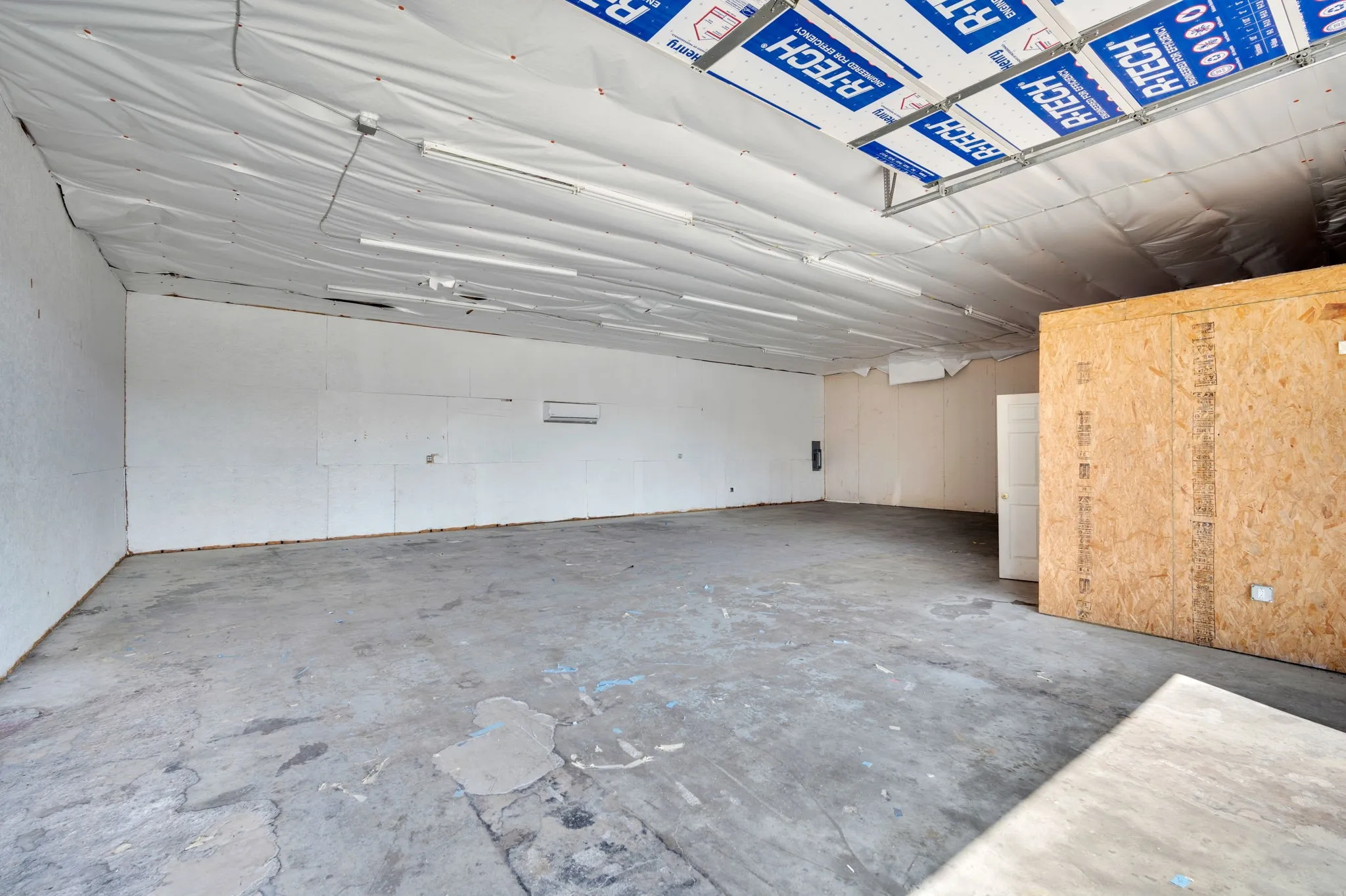 Bright, airy warehouse interior featuring skylight panels that flood the space with natural daylight.
