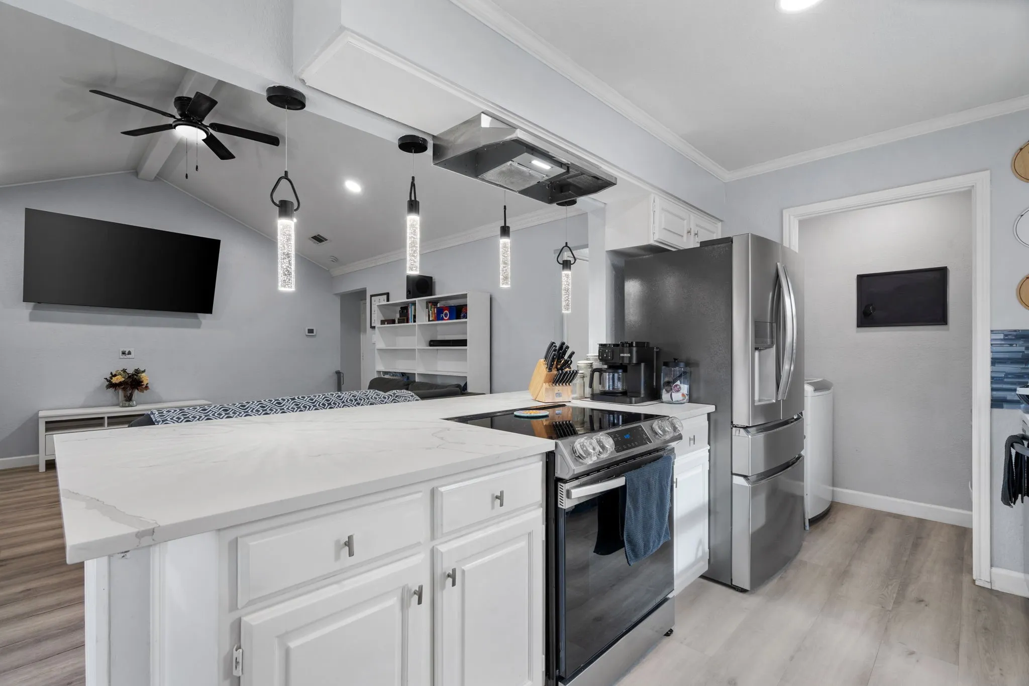 Kitchen island featuring a white countertop and white cabinetry with brushed nickel hardware