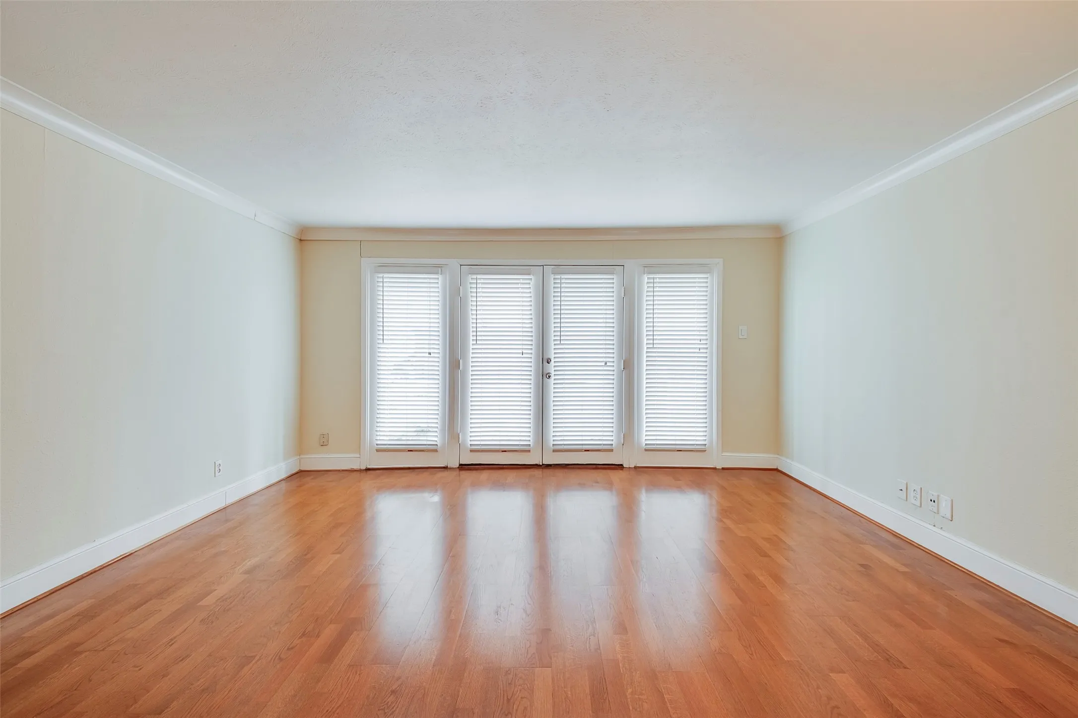 Unfurnished room featuring ornamental molding and light hardwood / wood-style flooring