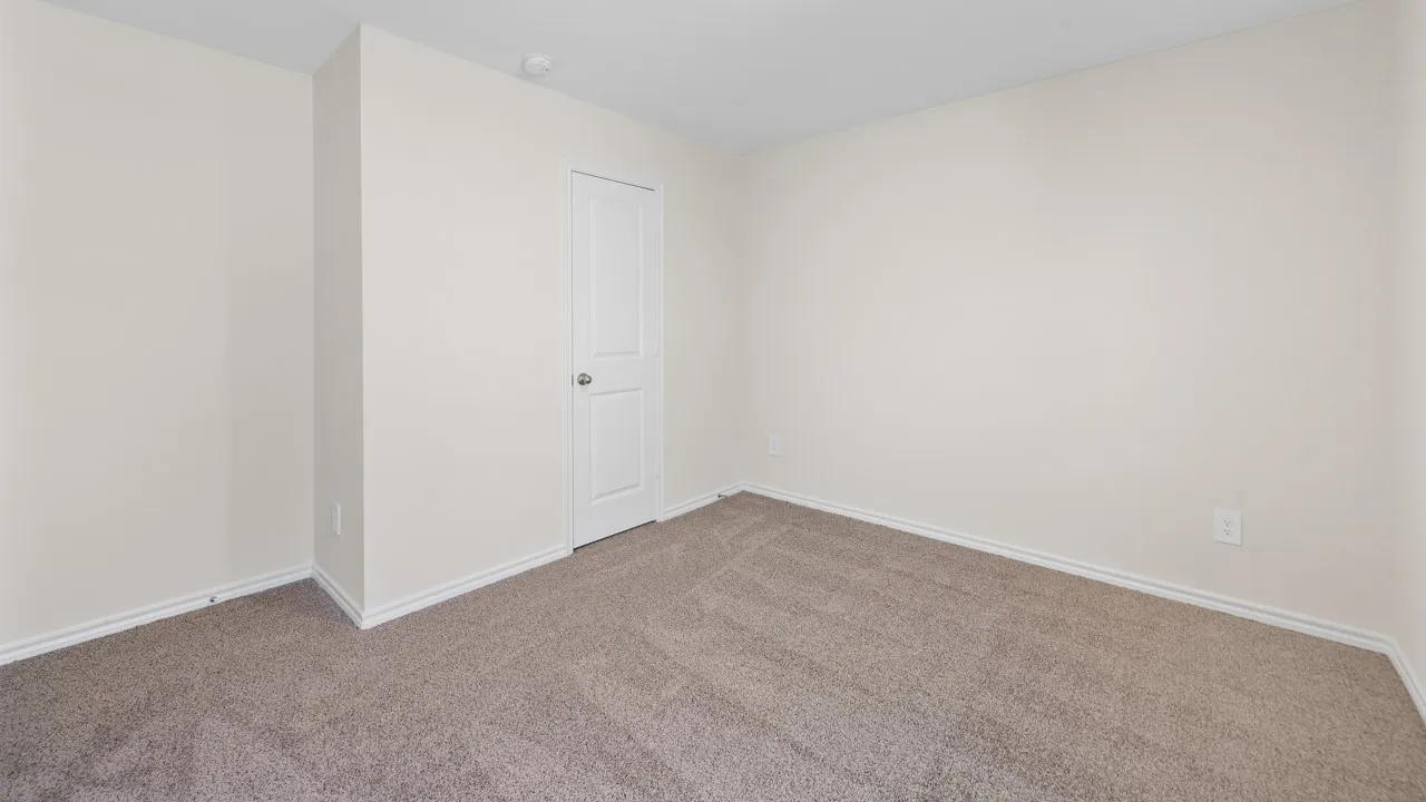 Neutral-toned walls complement the plush carpeting