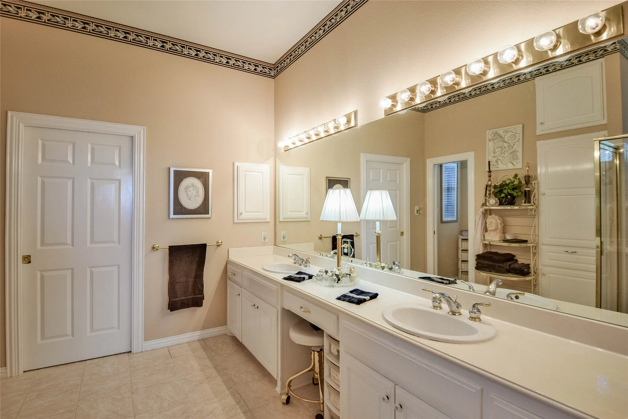 Full bathroom featuring double vanity and light tile patterned floors