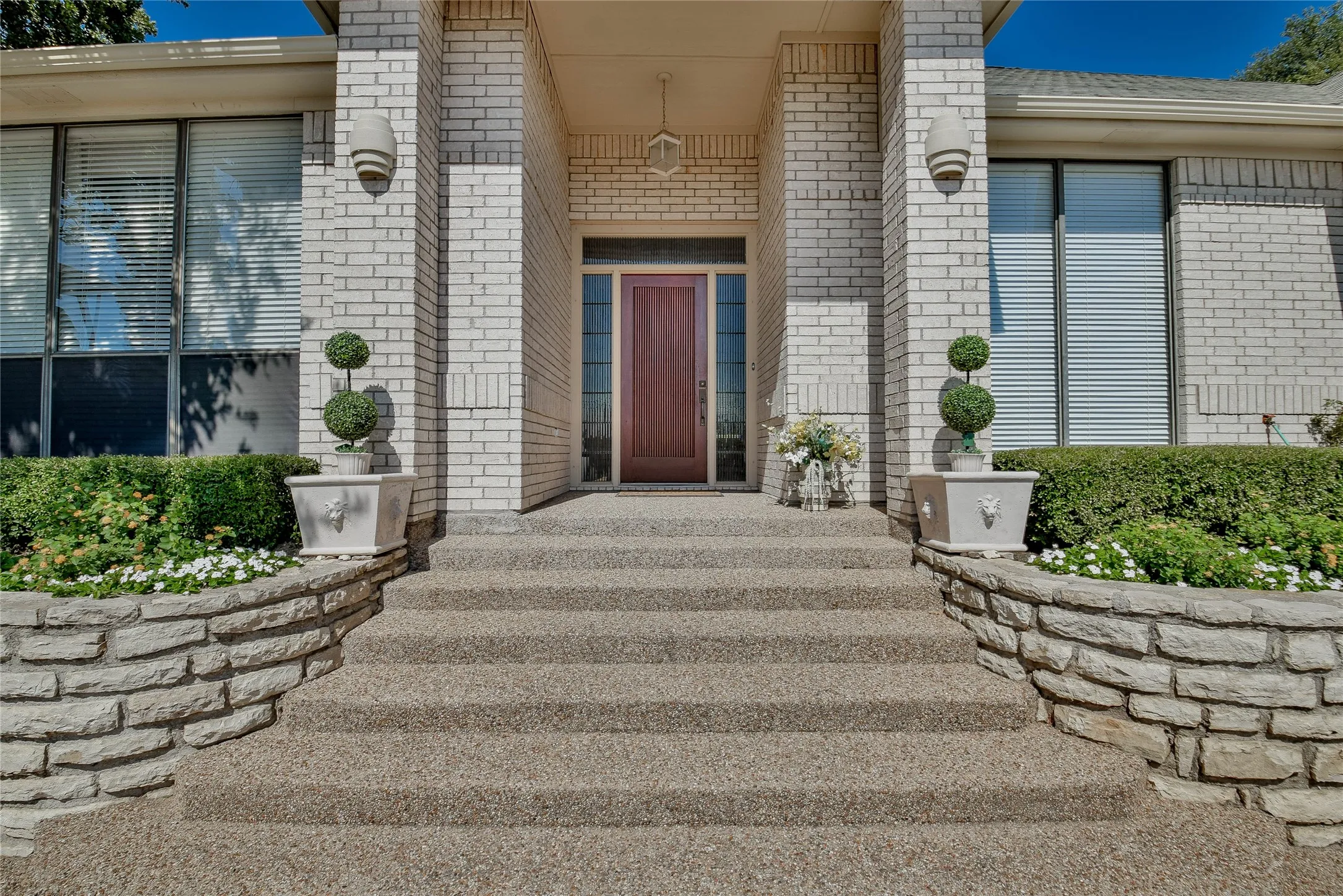 Doorway to property with brick siding and covered porch