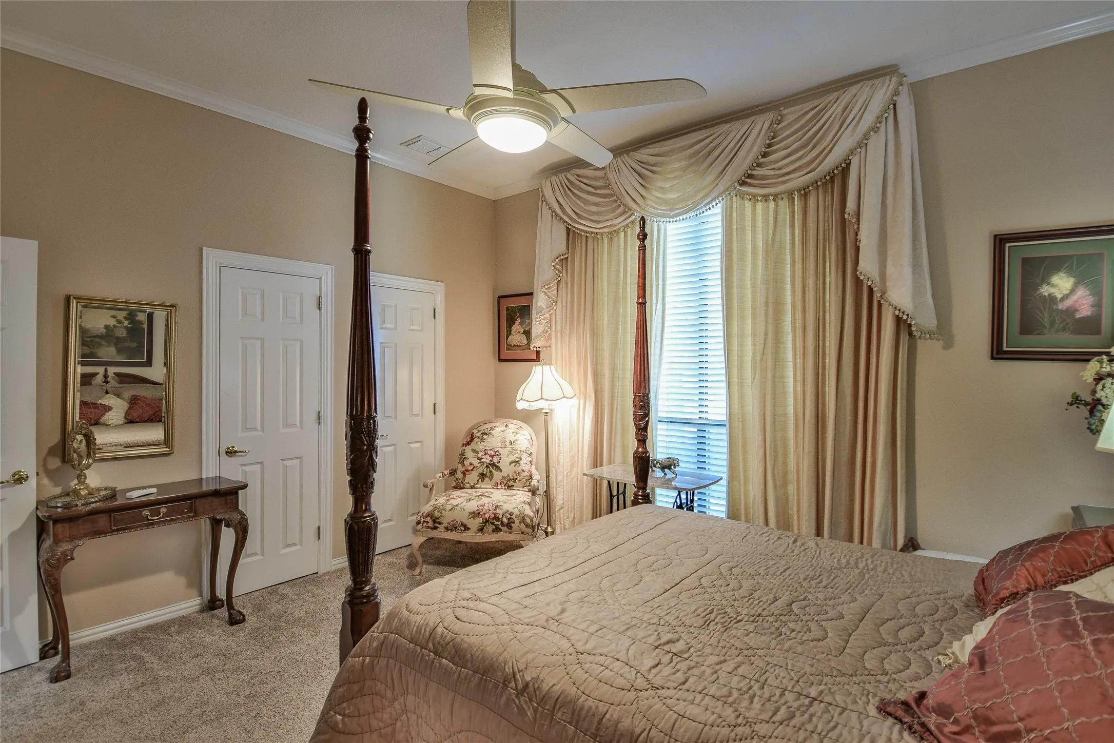 Bedroom featuring crown molding, light carpet, and a ceiling fan