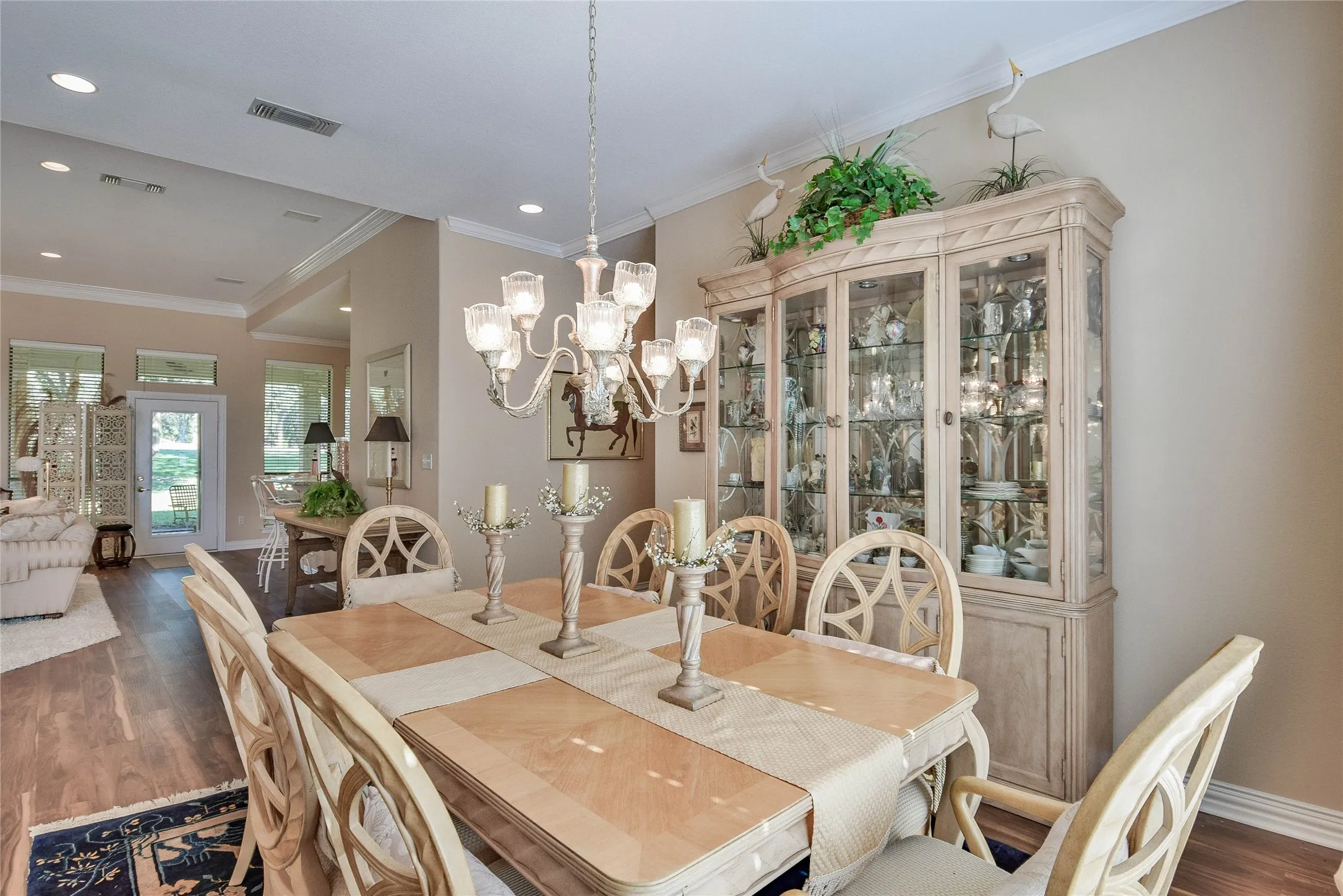 Dining area with ornamental molding, dark wood finished floors, a chandelier, and recessed lighting