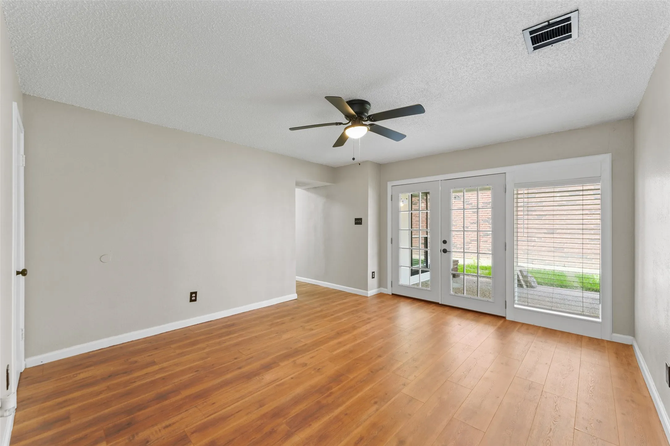Lower Living/Flex space with French doors to Covered Patio