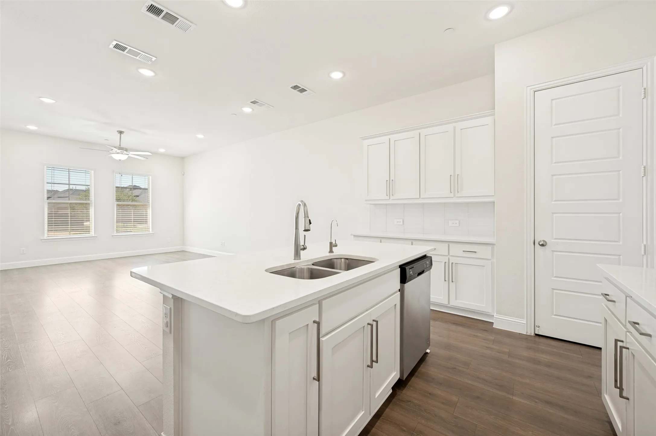 Modern kitchen island with a double basin sink and stainless steel faucet