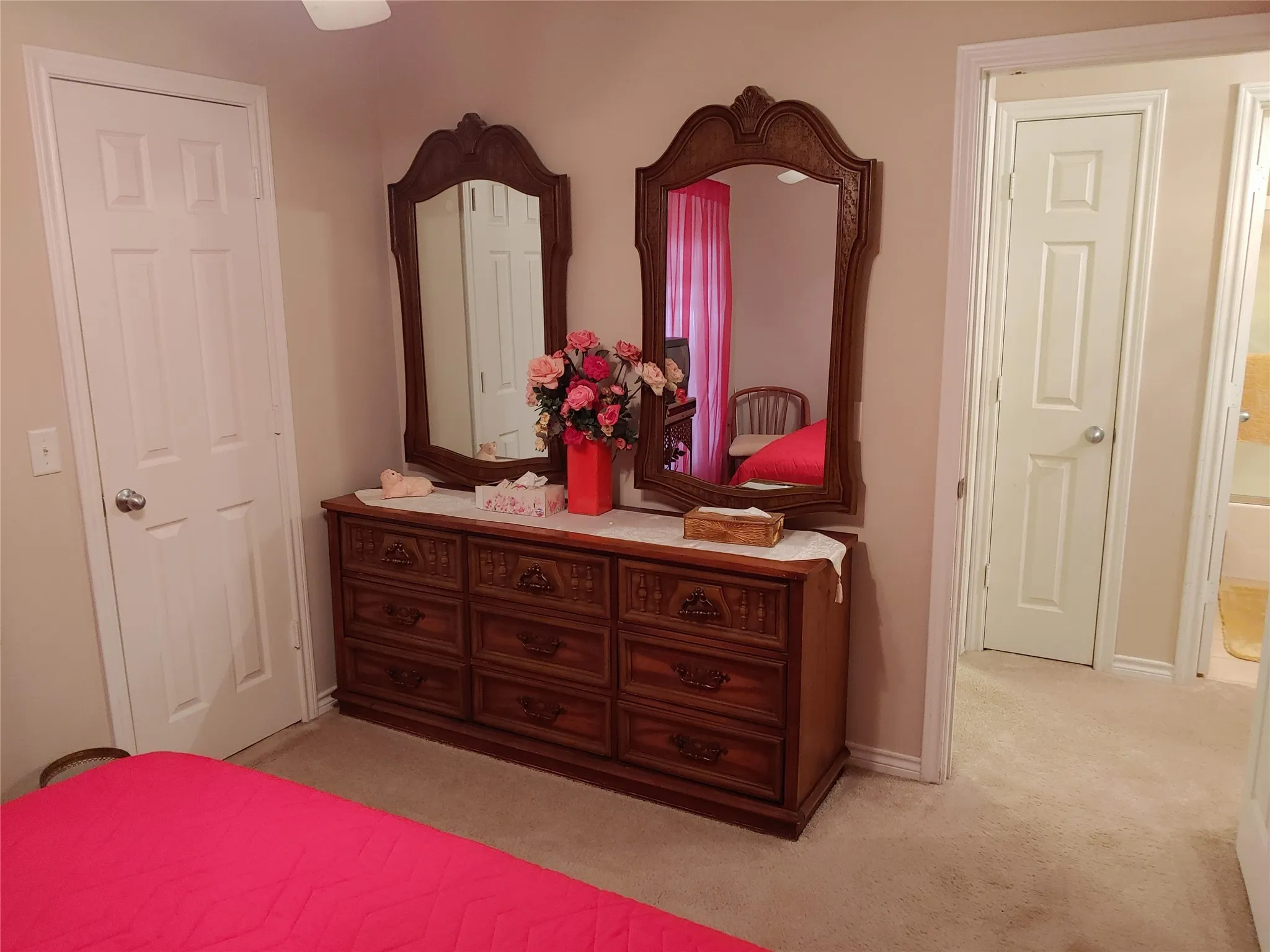 Carpeted room featuring a white paneled door and light-colored walls