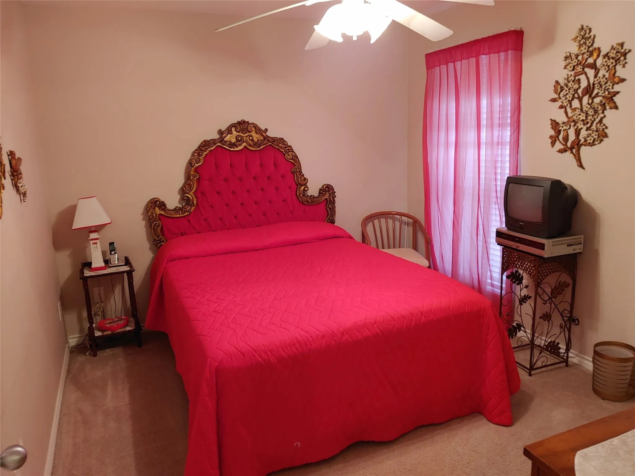 Carpeted room featuring a ceiling fan with integrated lighting, a window with blinds, and neutral-toned walls