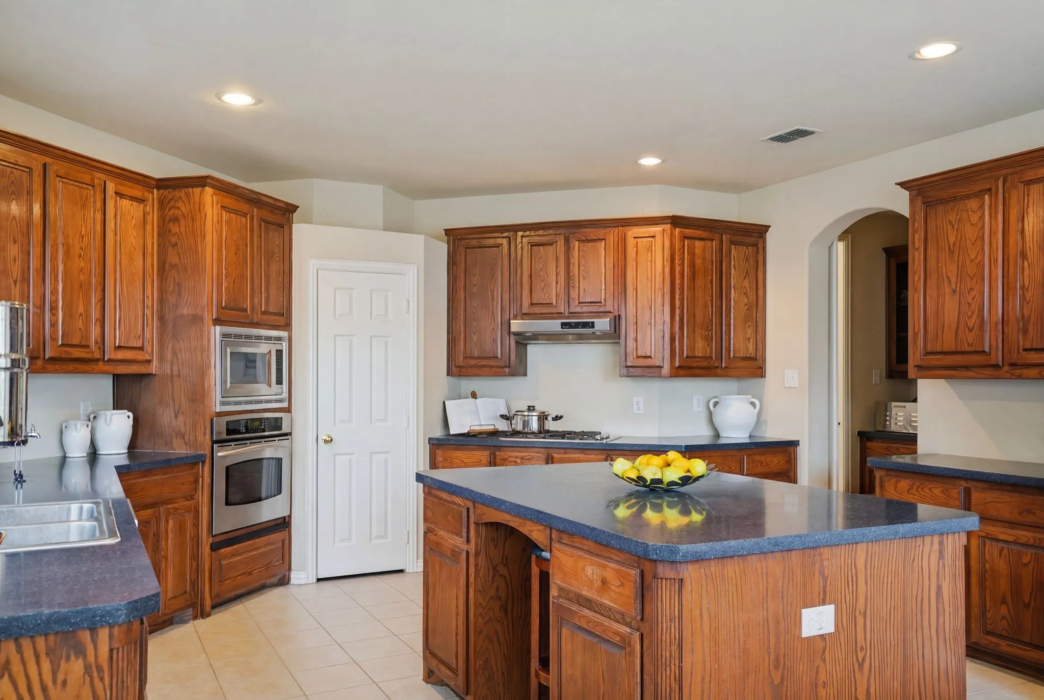 Designed for both everyday living and entertaining, the chef's kitchen offers abundant cabinetry, granite countertops, and an oversized island that naturally becomes the gathering place of the home.