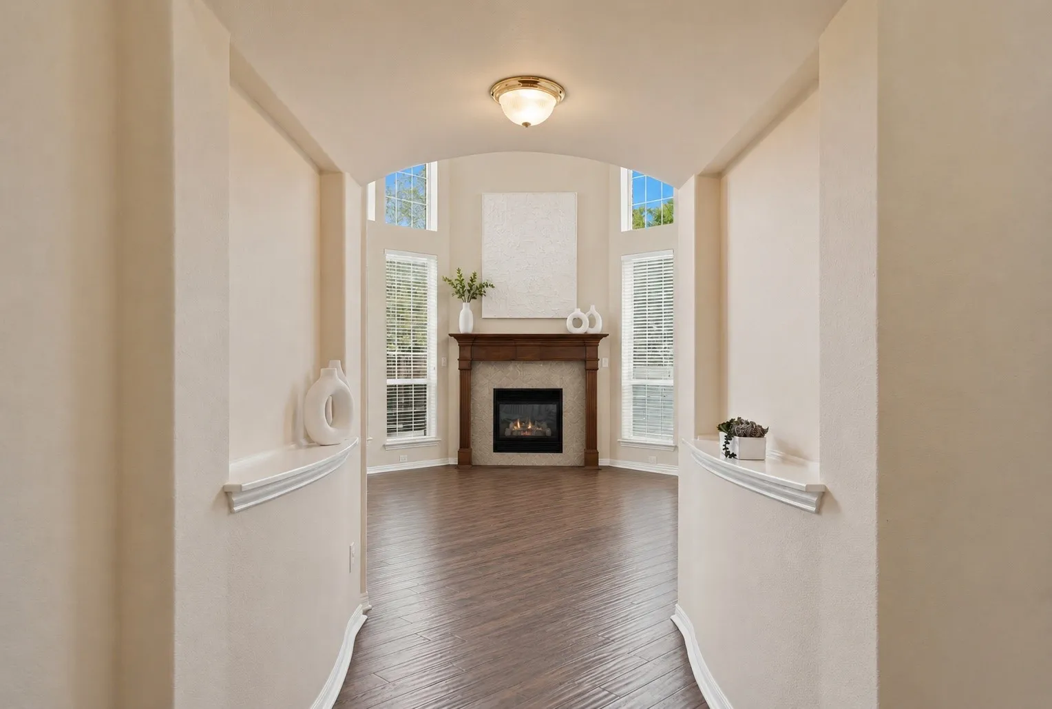 A dramatic sightline draws you through the home toward the soaring family room, creating an immediate sense of openness from the moment you arrive.