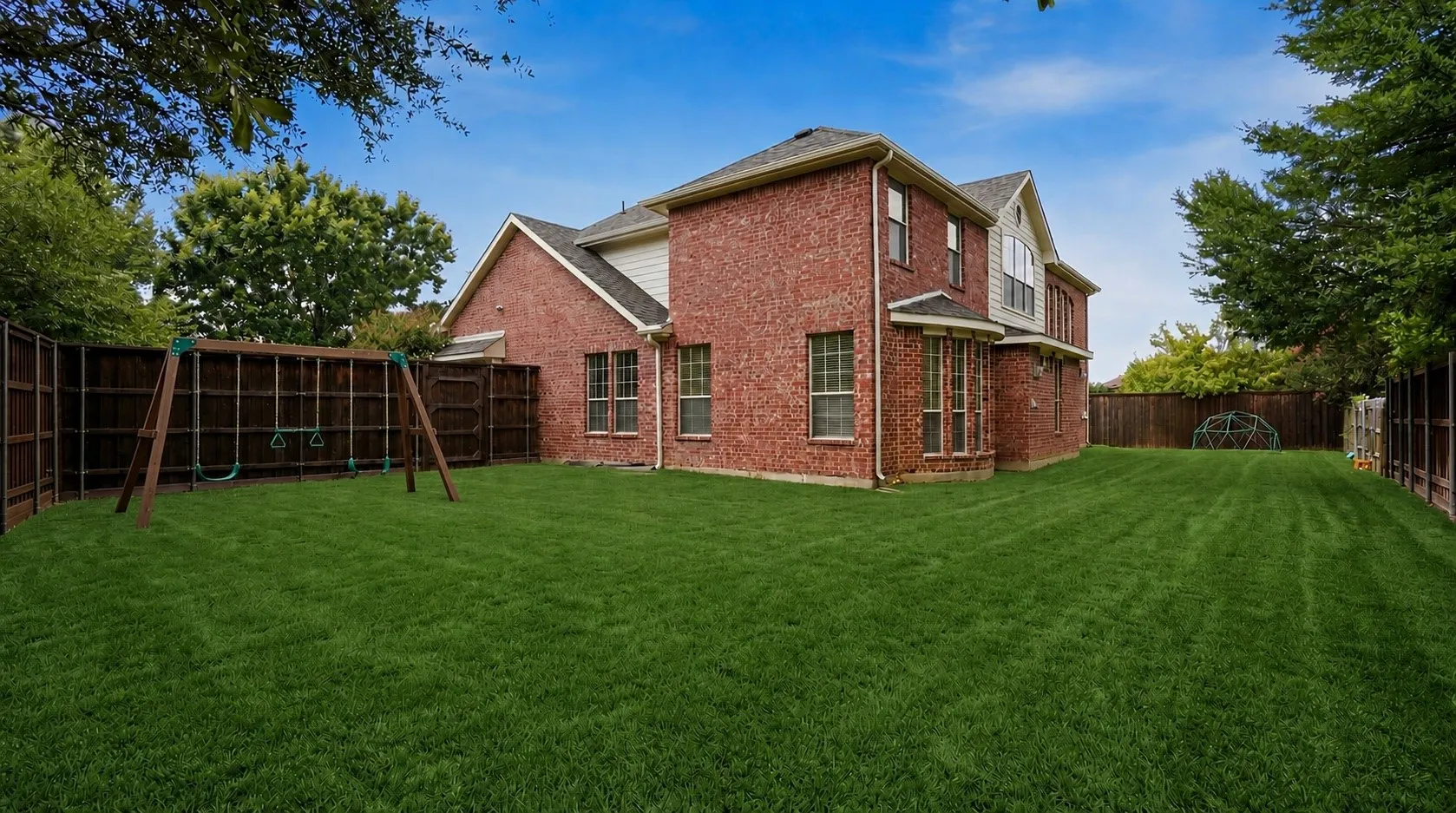 Wide open green space surrounds the home, offering room to relax, entertain, or customize your own private outdoor retreat.
