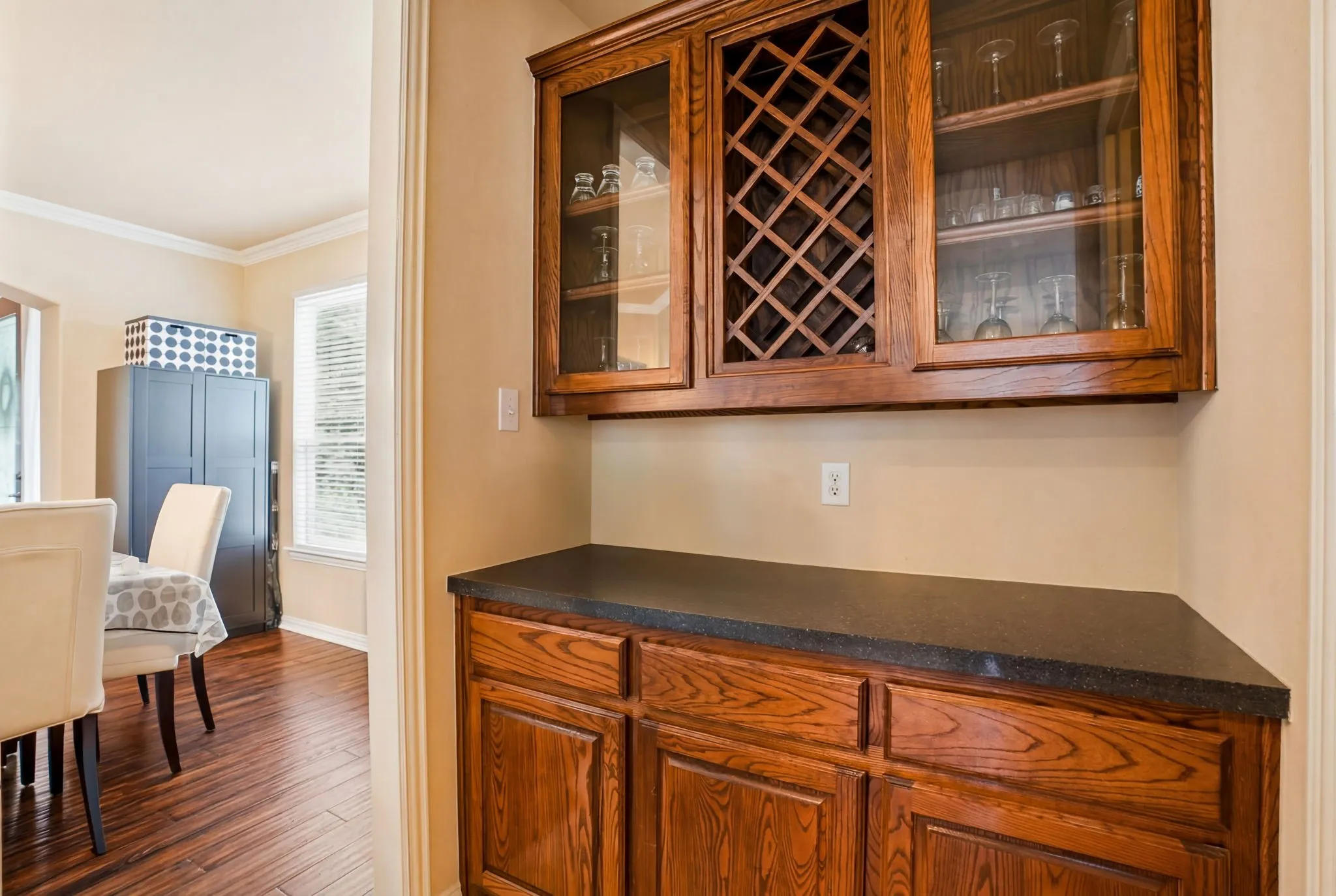 Custom built-in cabinetry and dedicated serving space provide exceptional storage while adding elegance and convenience for entertaining.