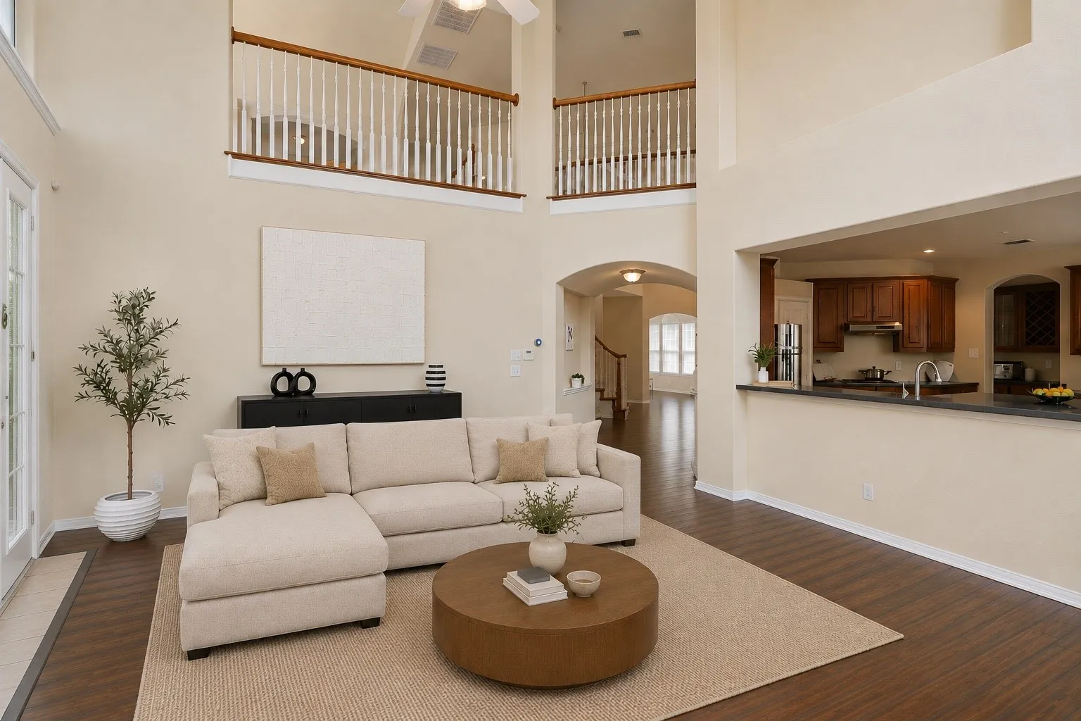 Anchored by a dramatic fireplace and framed by towering windows, the family room delivers an impressive blend of warmth, natural light, and architectural scale.