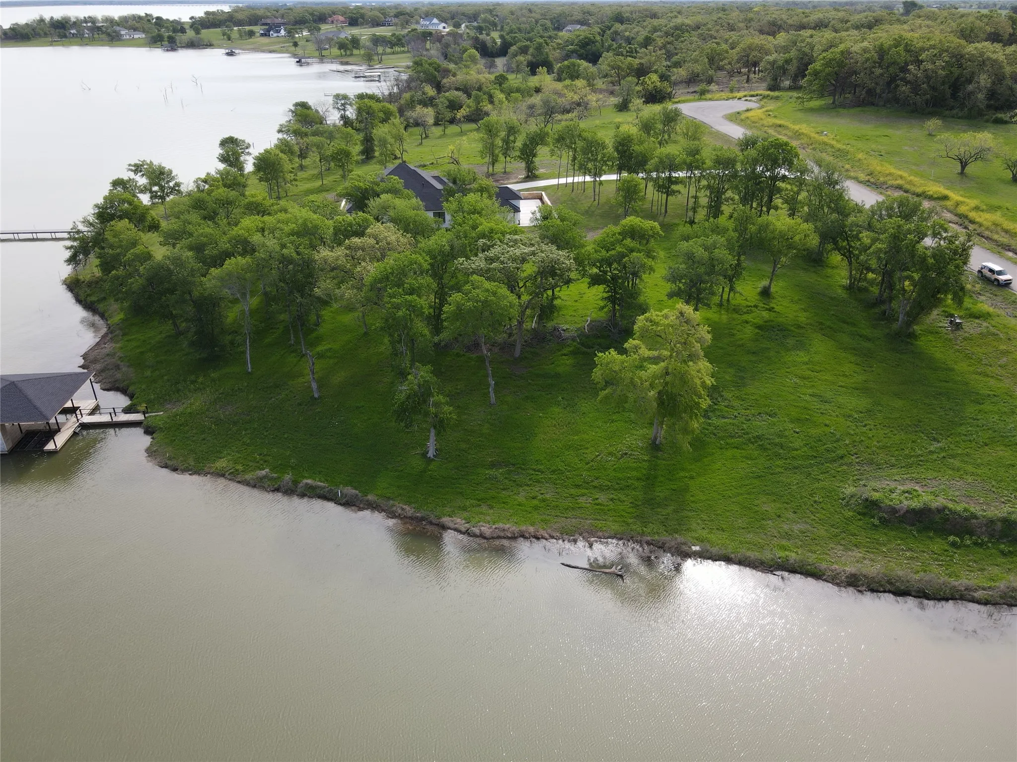 Aerial view shows the full waterfront point, shoreline, and surrounding Diamond Point lake community.