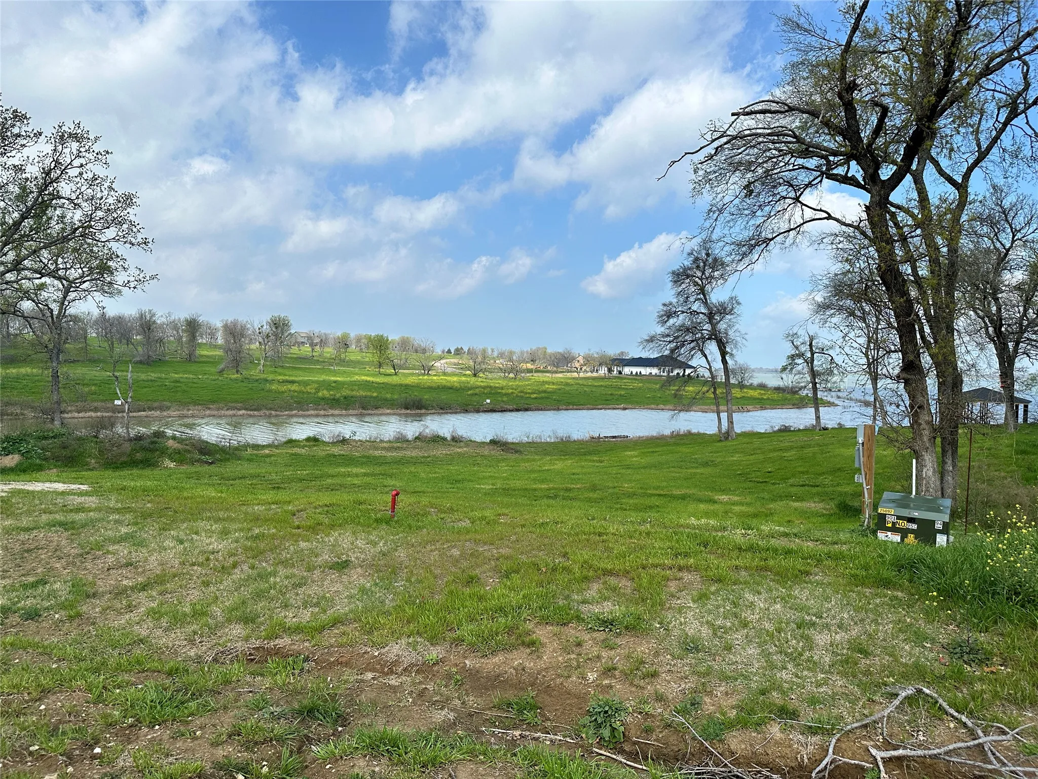Lakefront lot offers beautiful water views, grassy open space, and room to create your dream retreat.