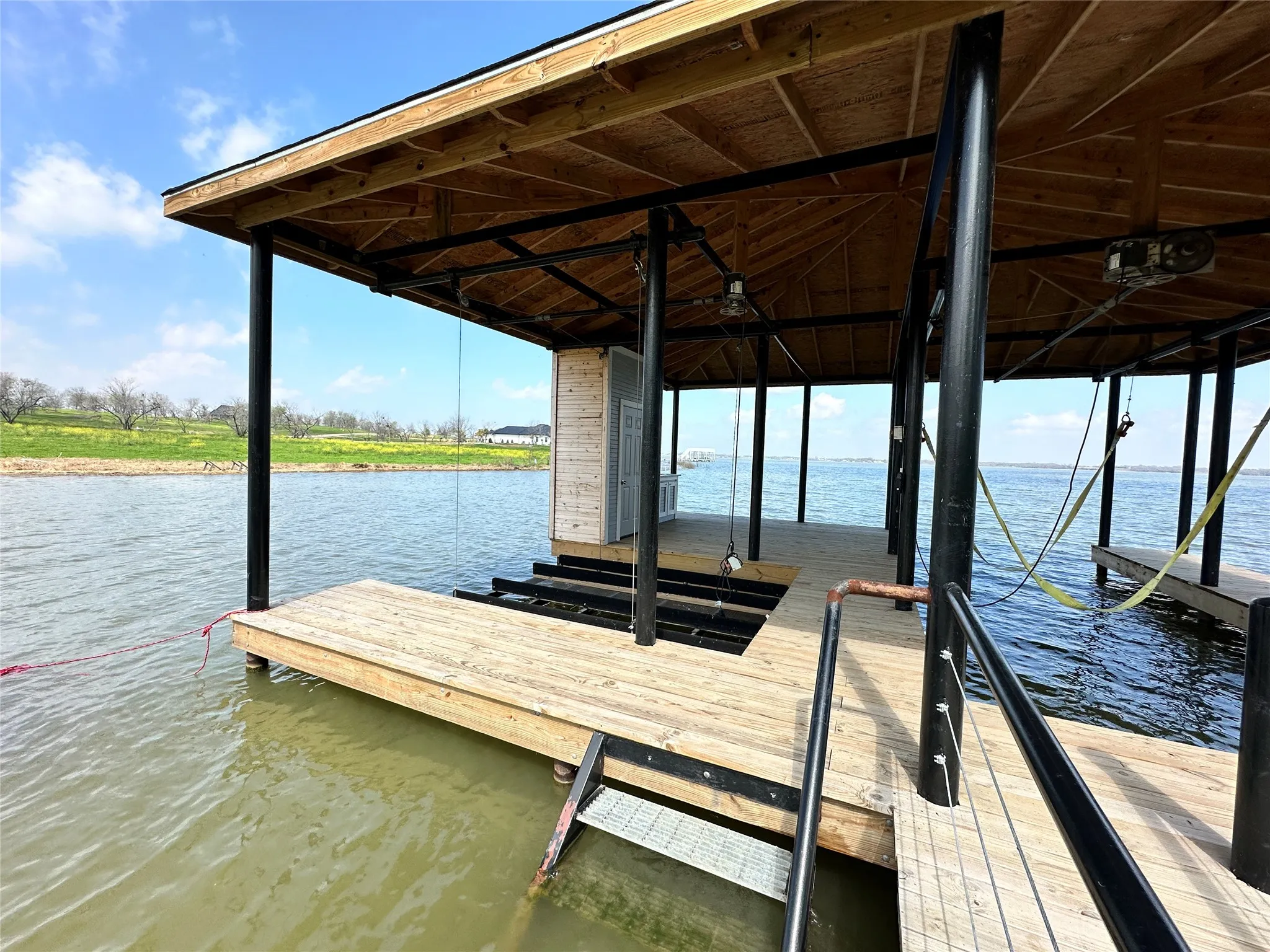 Inside the covered boathouse, enjoy functional lake access with room for boat and personal watercraft storage.