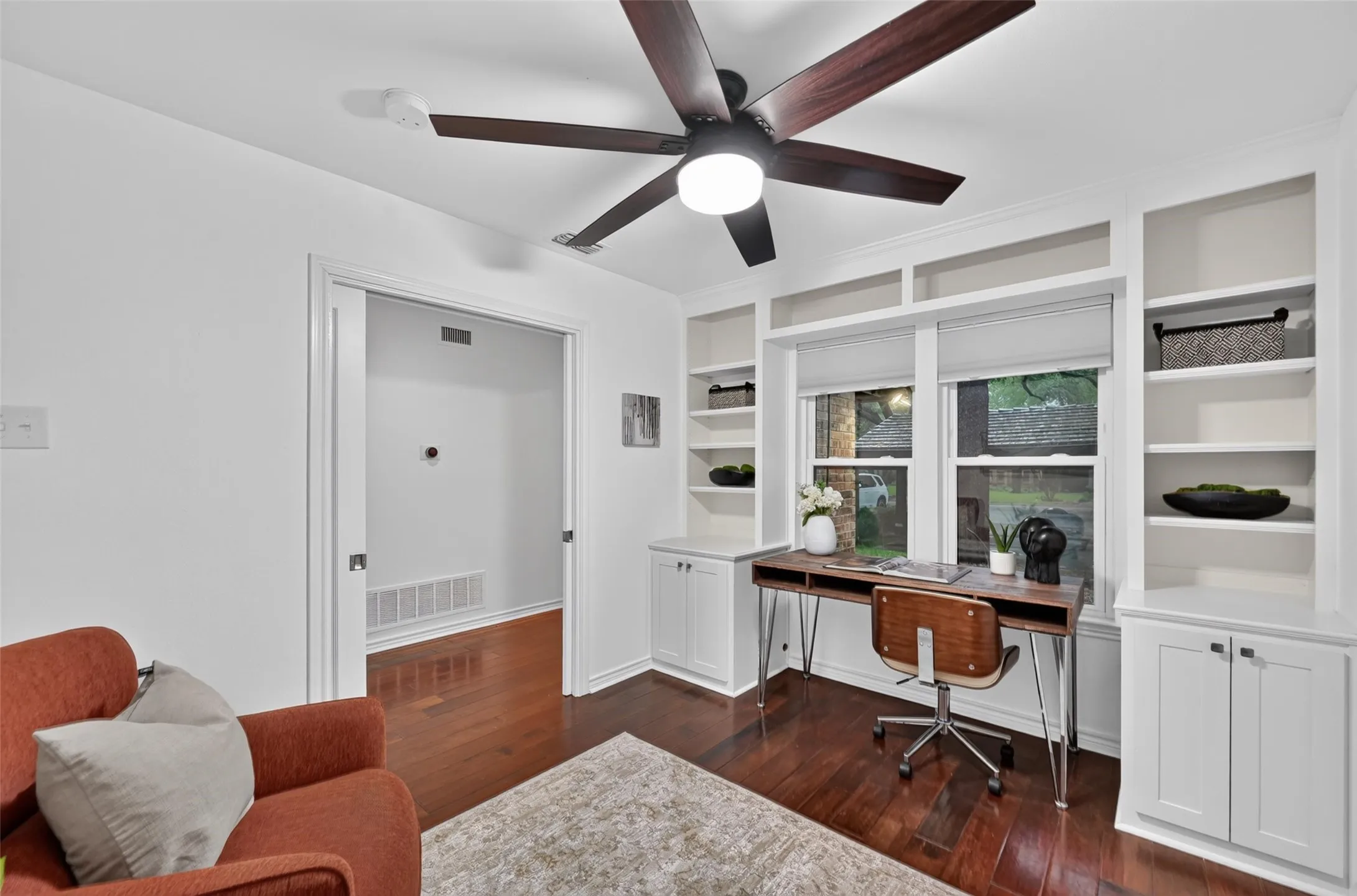 Recessed lighting, wood-finish flooring, built-in shelving, white cabinetry, and a ceiling fan with integrated light
