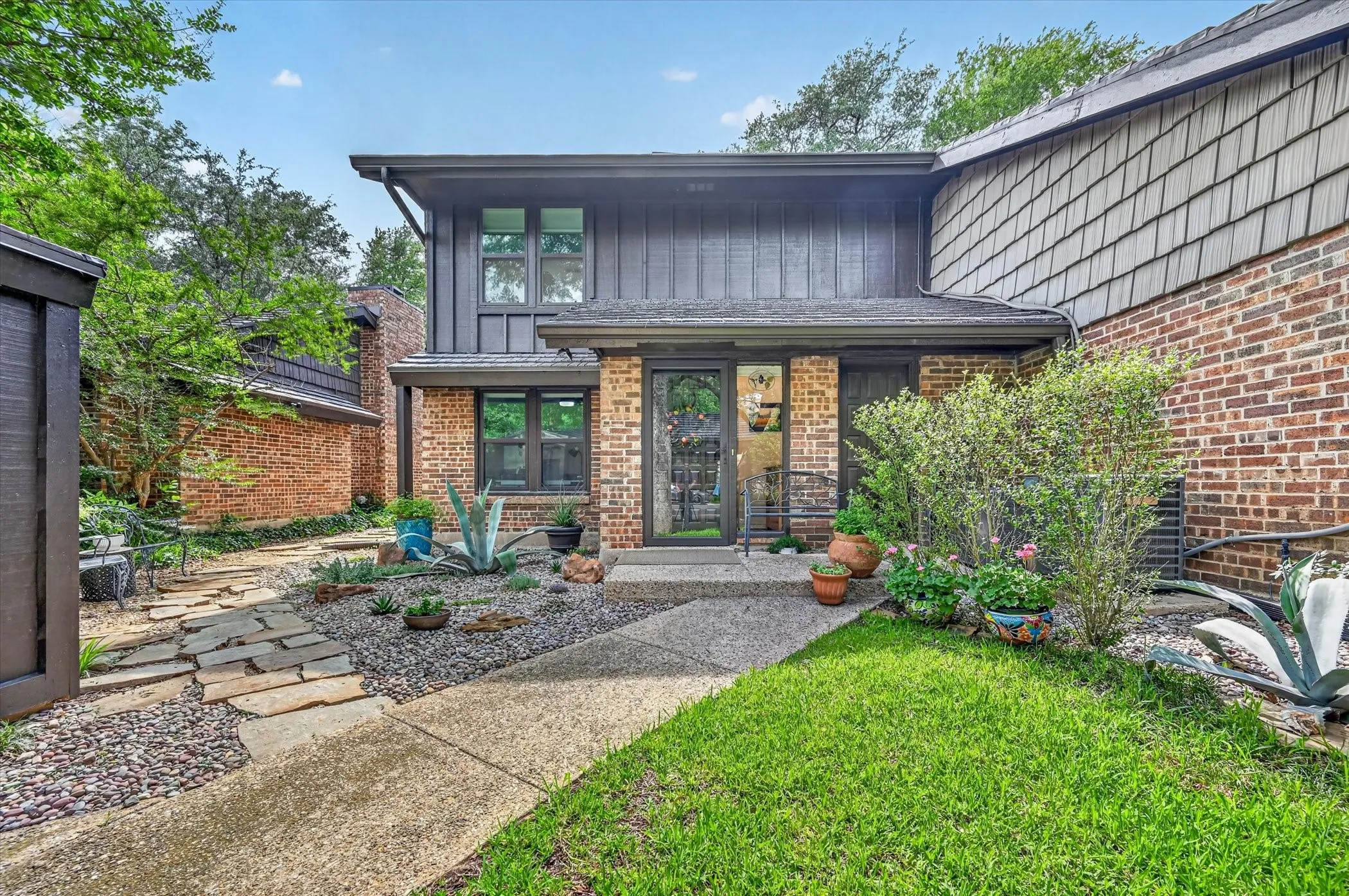 Brick and vertical siding facade with wood shingle accents