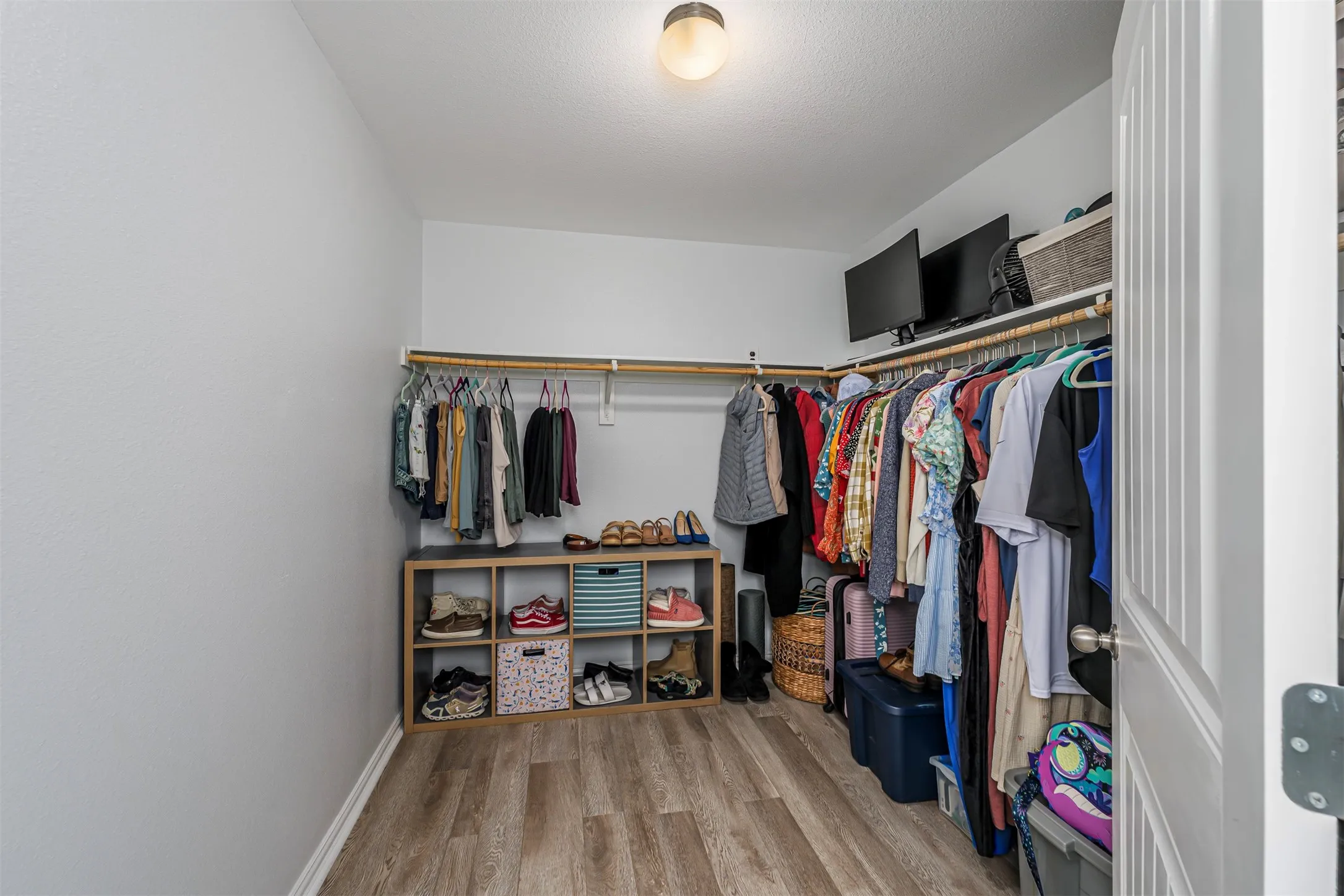 Walk in closet featuring light wood-type flooring