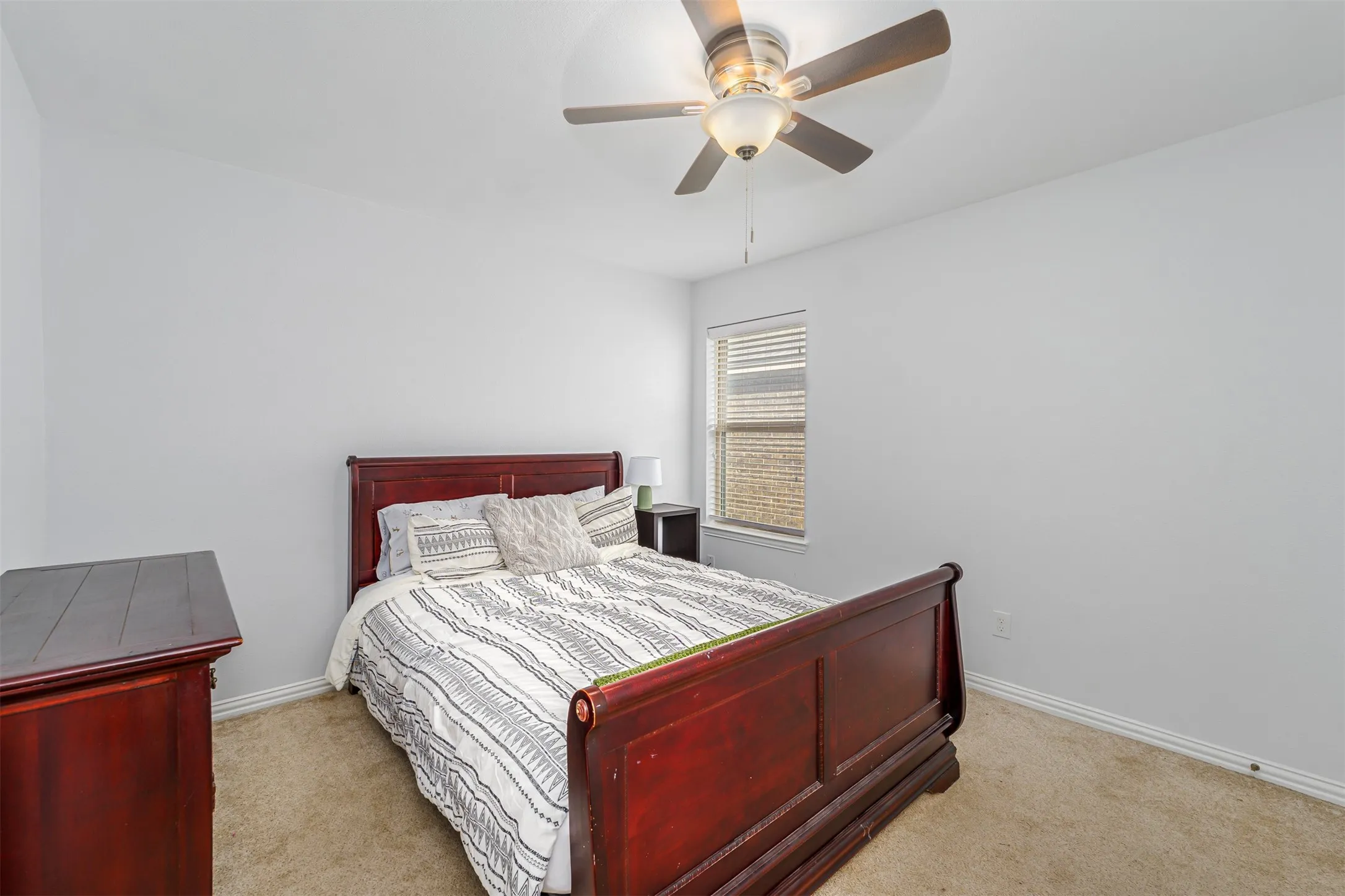 Bedroom featuring light carpet and ceiling fan