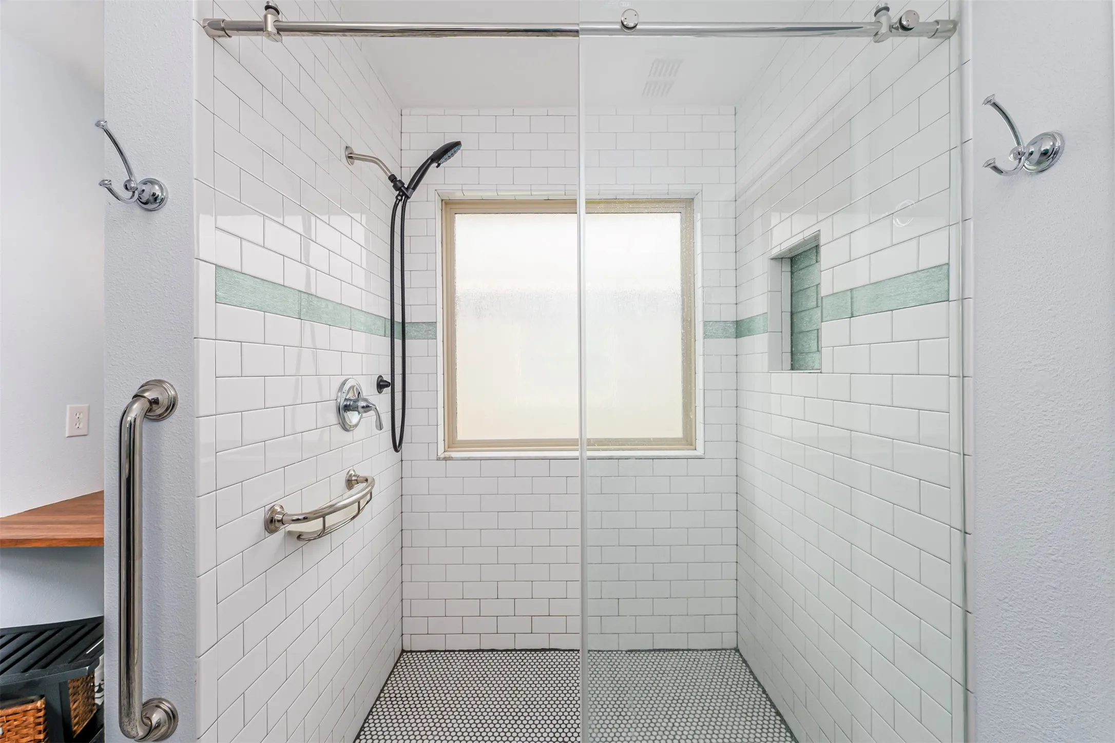 Full bathroom with a tile shower and a textured wall