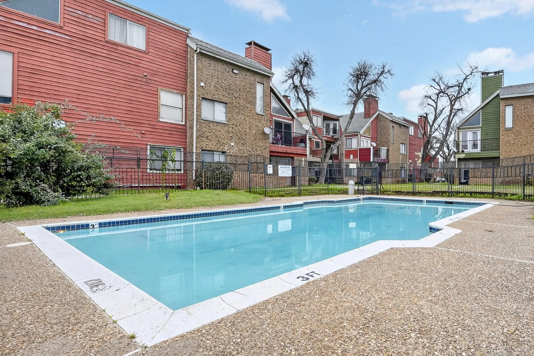 Community swimming pool with a surrounding aggregate concrete deck