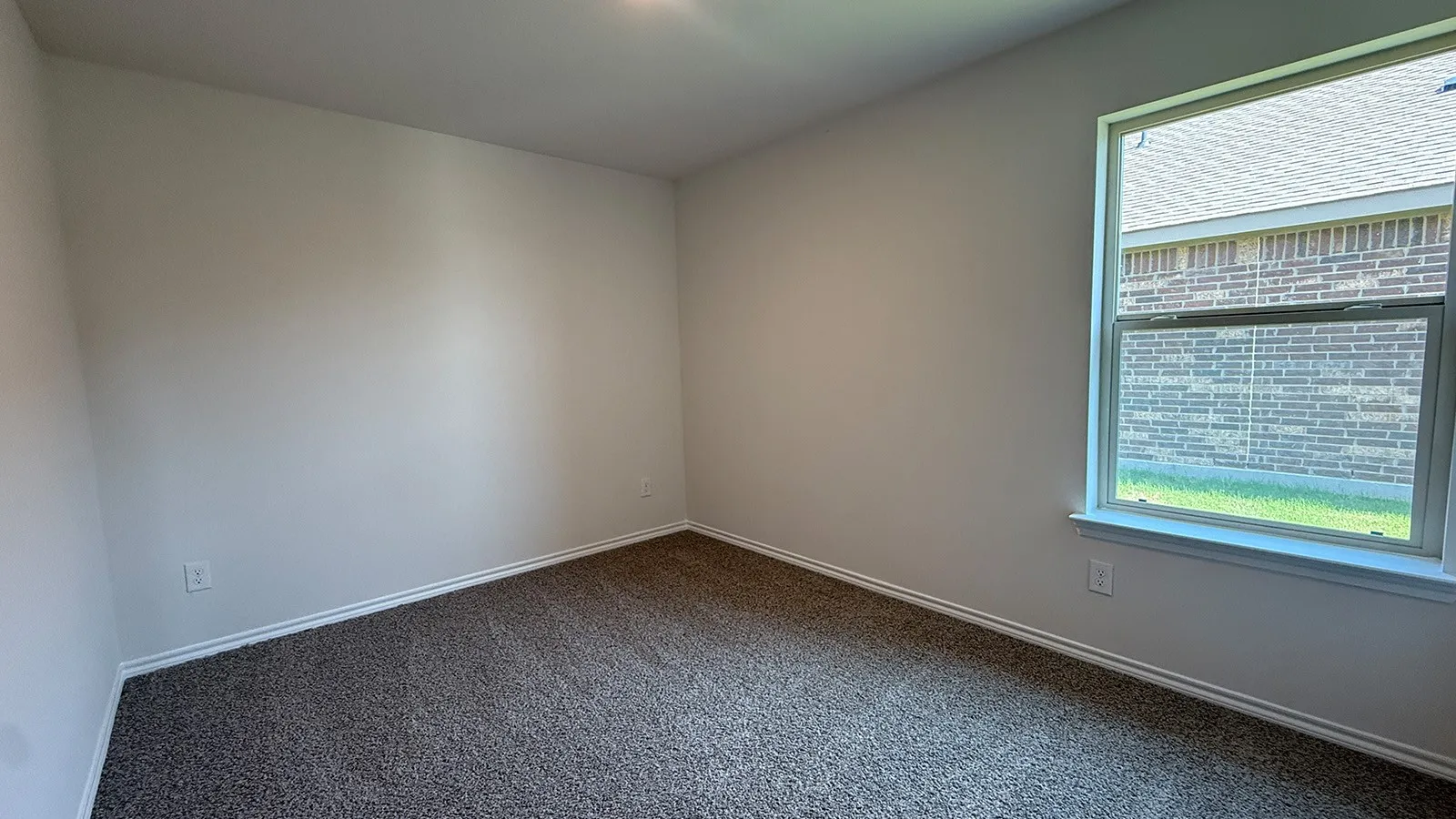 Neutral wall paint and dark textured carpeting provide a versatile interior palette