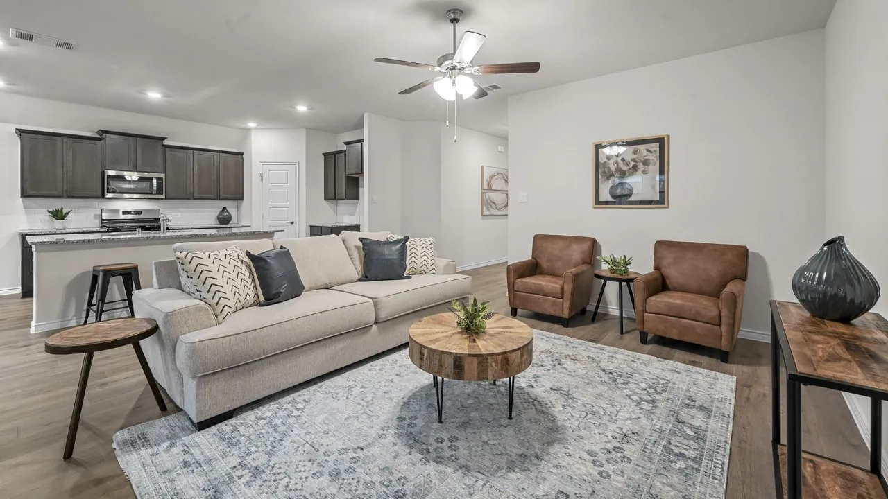 Open-concept living space featuring wood-finish flooring, a ceiling fan, and recessed lighting