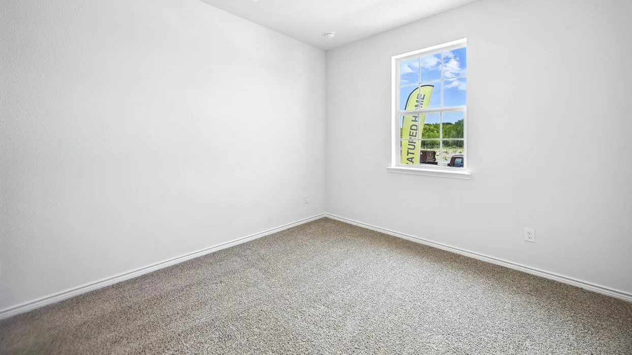 Neutral color palette room featuring light-colored carpet, white walls, and a single window with white trim